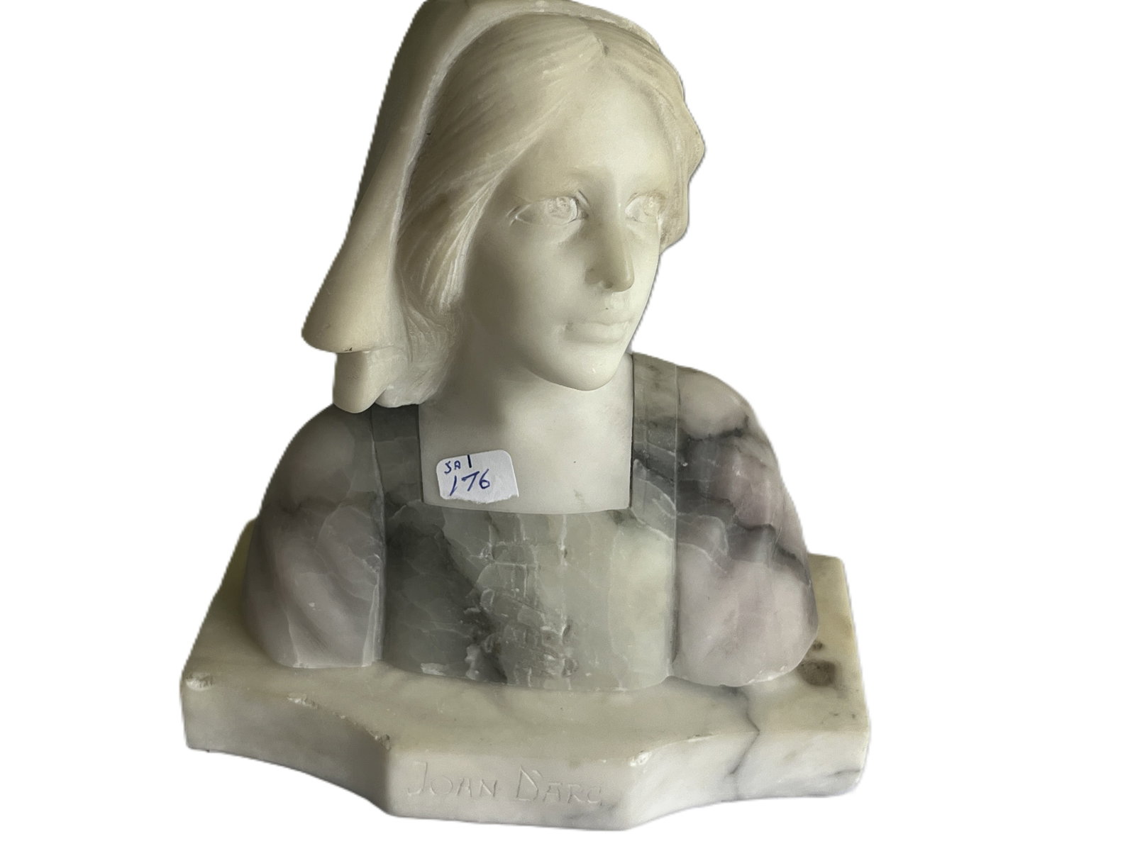 Joan of Arc Marble Bust. 7"h: Finely carved bust of Joan of Arc in polished alabaster and variegated marble, depicting the heroine in a contemplative pose with veil and square neckline. The contrasting stone tones̵
