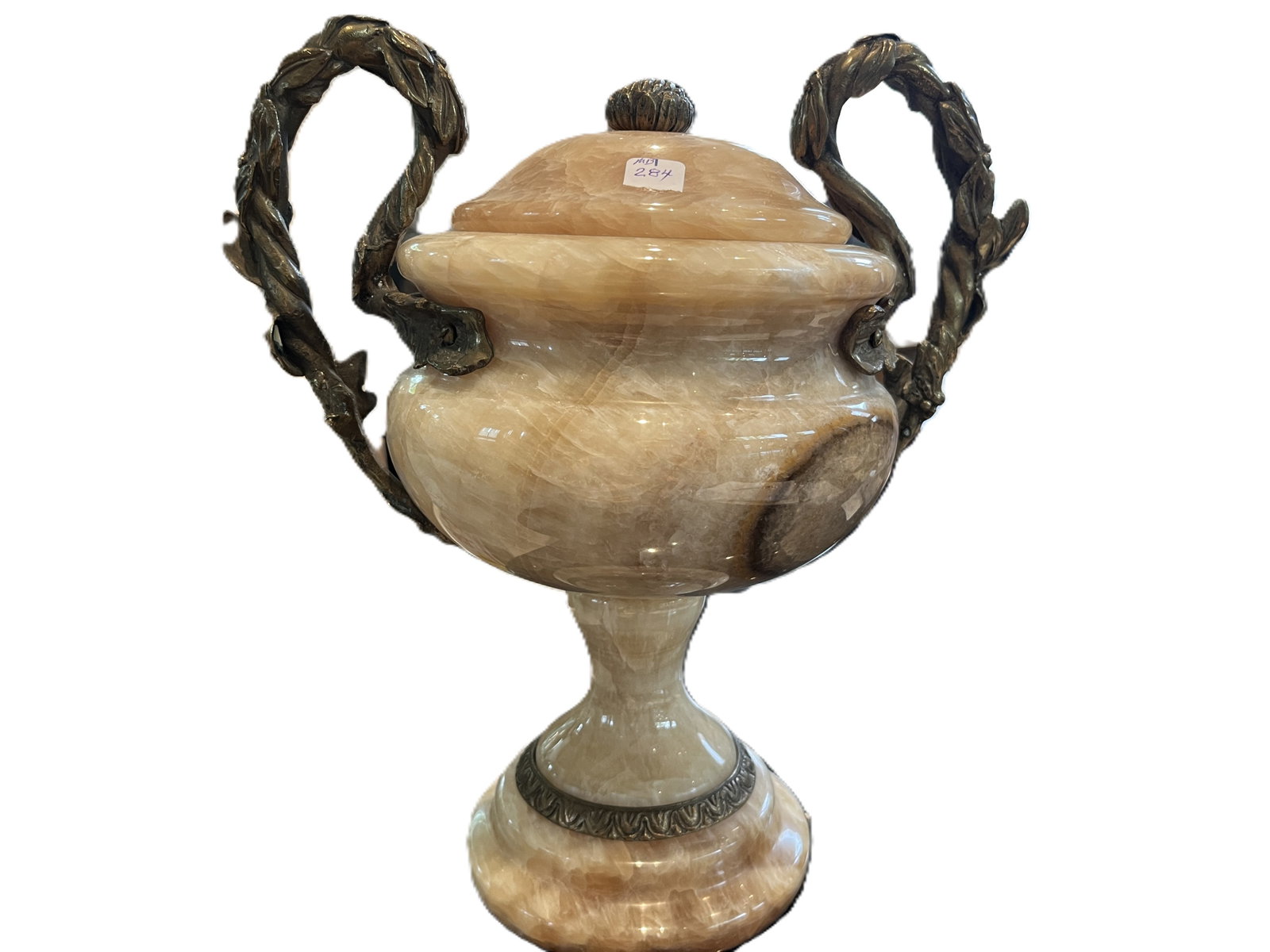 Vintage Solid Onyx Urn with Bronze Mounts, 12"H×11"W×7"D: A finely carved solid onyx urn with bronze mounts, featuring twin laurel‑wreath handles and a classical leaf‑scroll band at the base. The natural stone displays warm honey‑cream vein