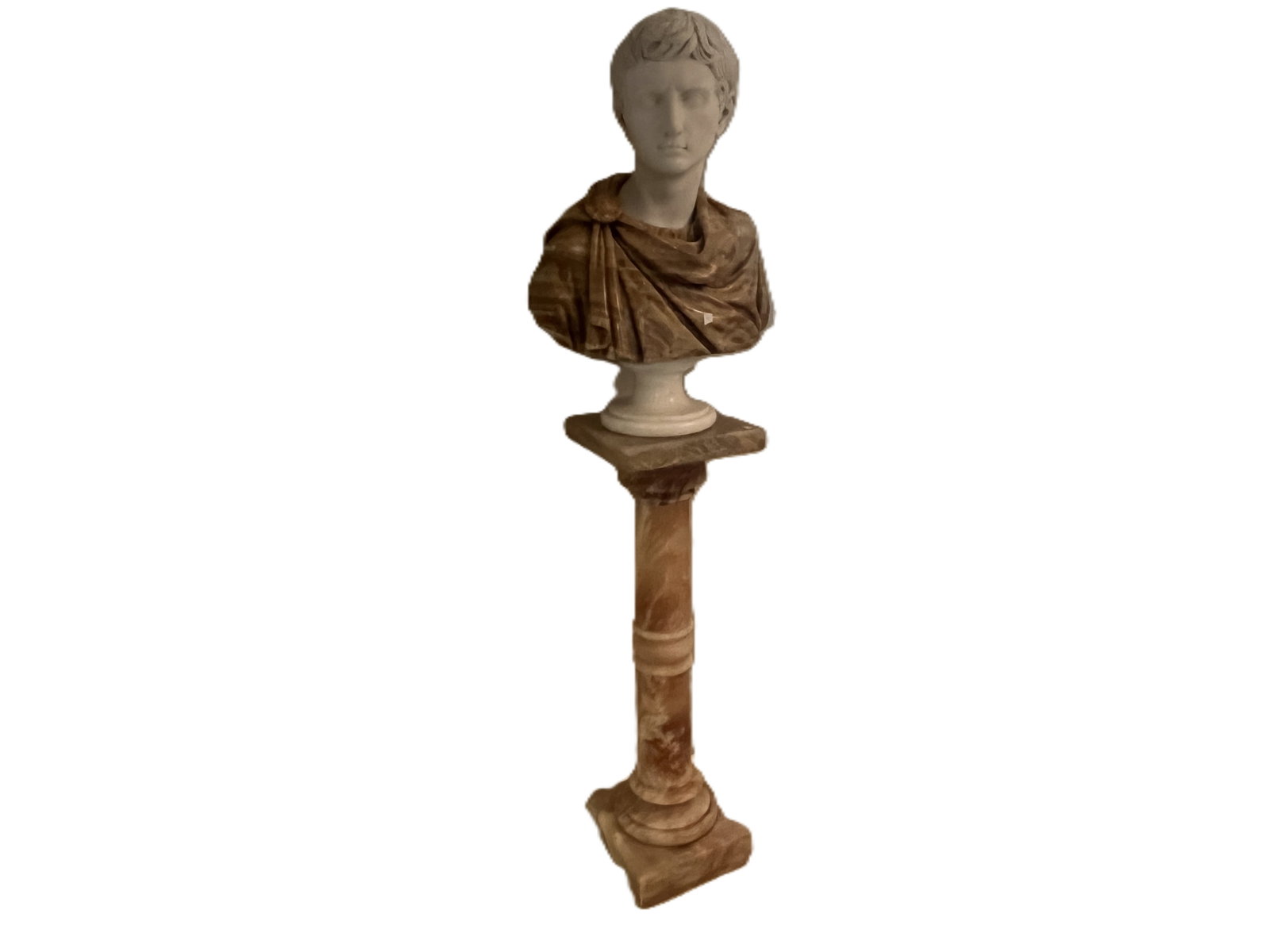 Grand Tour Marble and Onyx Bust of Augustus Caesar on Pedestal, total height 71": Finely modeled bust of Augustus Caesar, rendered in contrasting marbles with crisp facial detail and deeply cut folds. The warm brown onyx toga and pedestal create a striking visual contrast against t