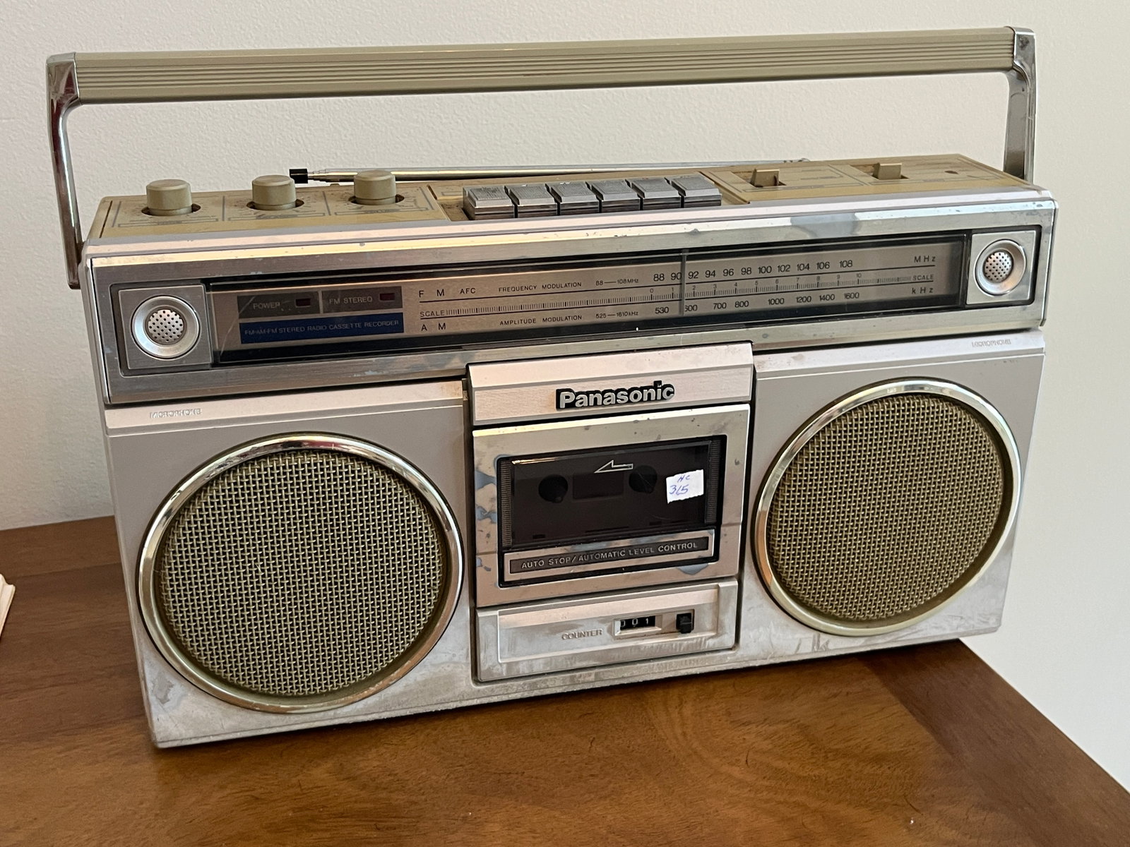 Vintage Panasonic AM/FM Stereo Cassette Boombox Portable Radio Recorder: Vintage Panasonic portable AM/FM stereo radio cassette recorder featuring dual speakers, integrated cassette deck, carrying handle, analog tuning dial, and top-mounted controls. Finished in silver-ton