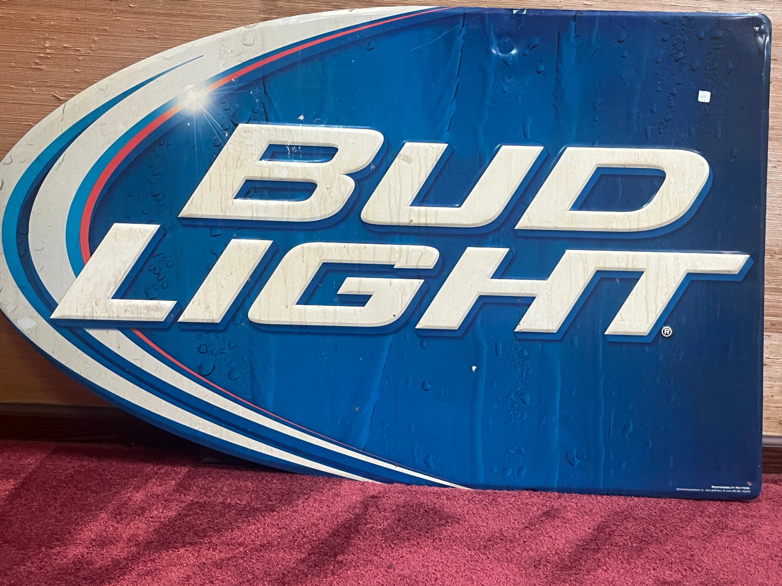 Large Bud Light Embossed Tin Advertising Sign, 29.5 x 32 In.: Large vintage Bud Light advertising sign featuring the iconic blue and white logo in raised embossed lettering. Constructed of painted tin with rounded corners, this eye-catching breweriana display wa