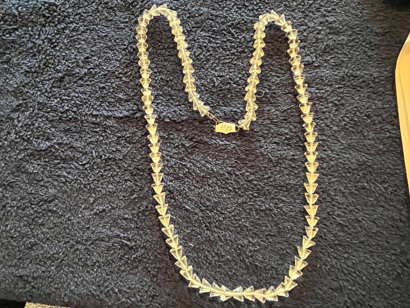 Vintage 33"Clear Crystal Necklace with Unusual Double Cone Faceted Beads: A vintage clear crystal necklace composed of precision cut double cone beads, each tapering to a central waist that creates a striking optical effect. The beads are strung in continuous formation, pro
