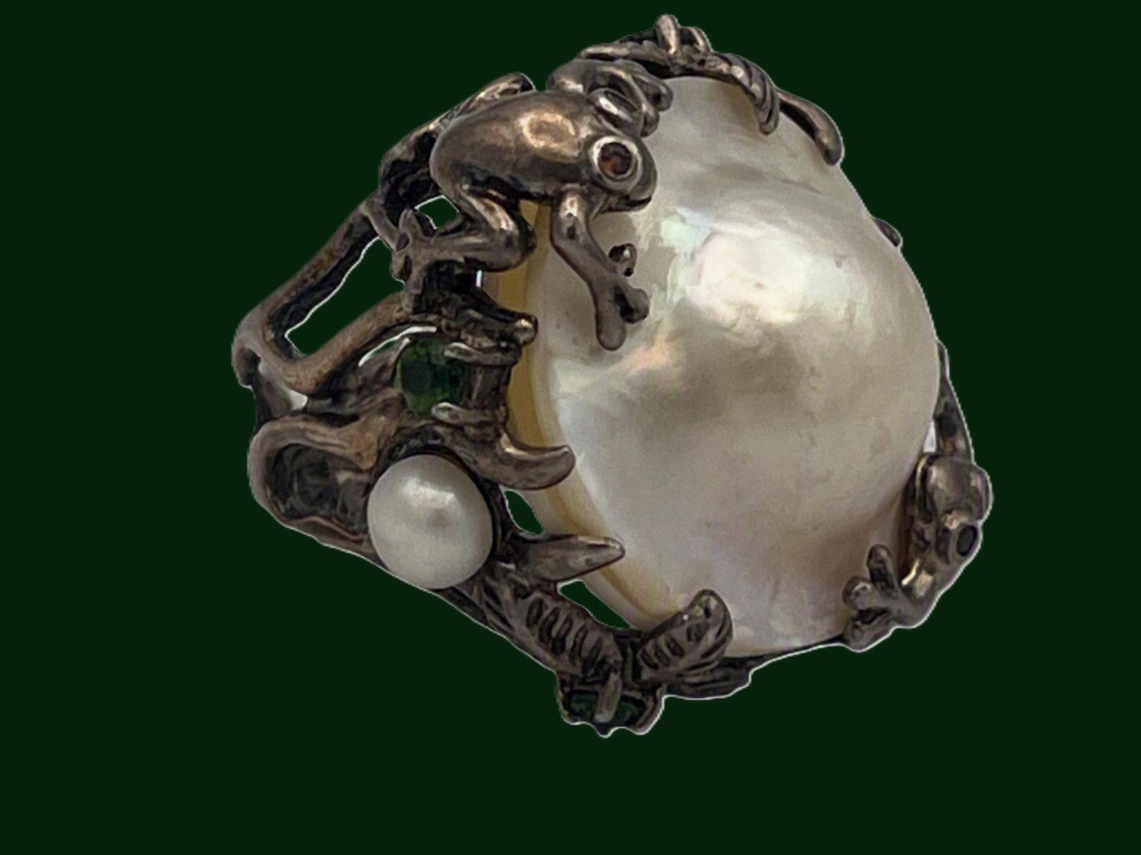 Art Nouveau Style Sterling Silver Frog & Cultured Pearl Ring: This imaginative sterling ring showcases a large cultured baroque pearl with subtle mauve iridescence, embraced by a whimsical network of frogs and foliage rendered in high?relief silver. The design e