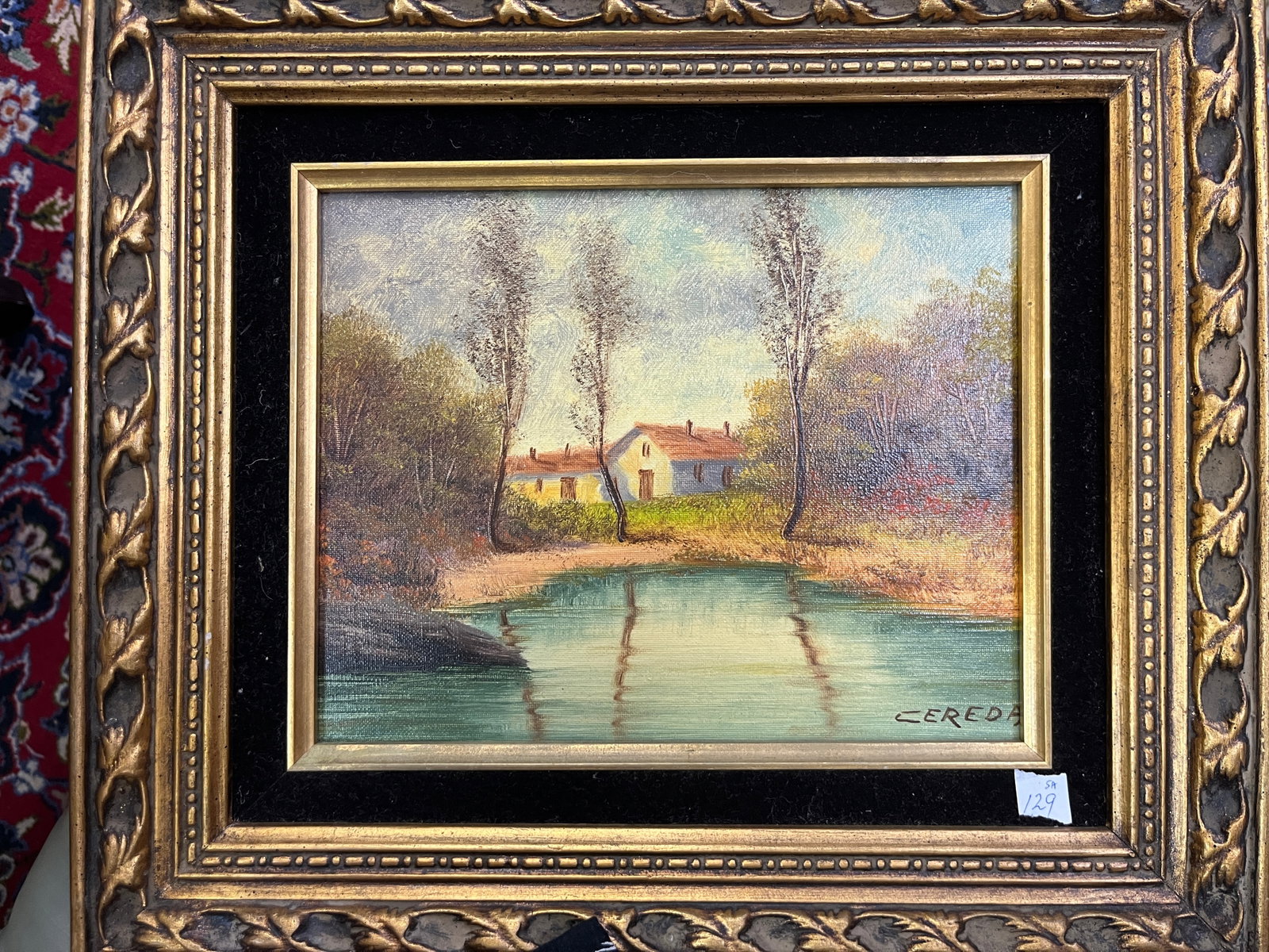 Oil on Canvas Landscape by Cereda, 8x10: Charming oil on canvas landscape depicting a tranquil rural scene with a small white house nestled among tall trees beside a reflective pond. The composition captures soft daylight and delicate brushw