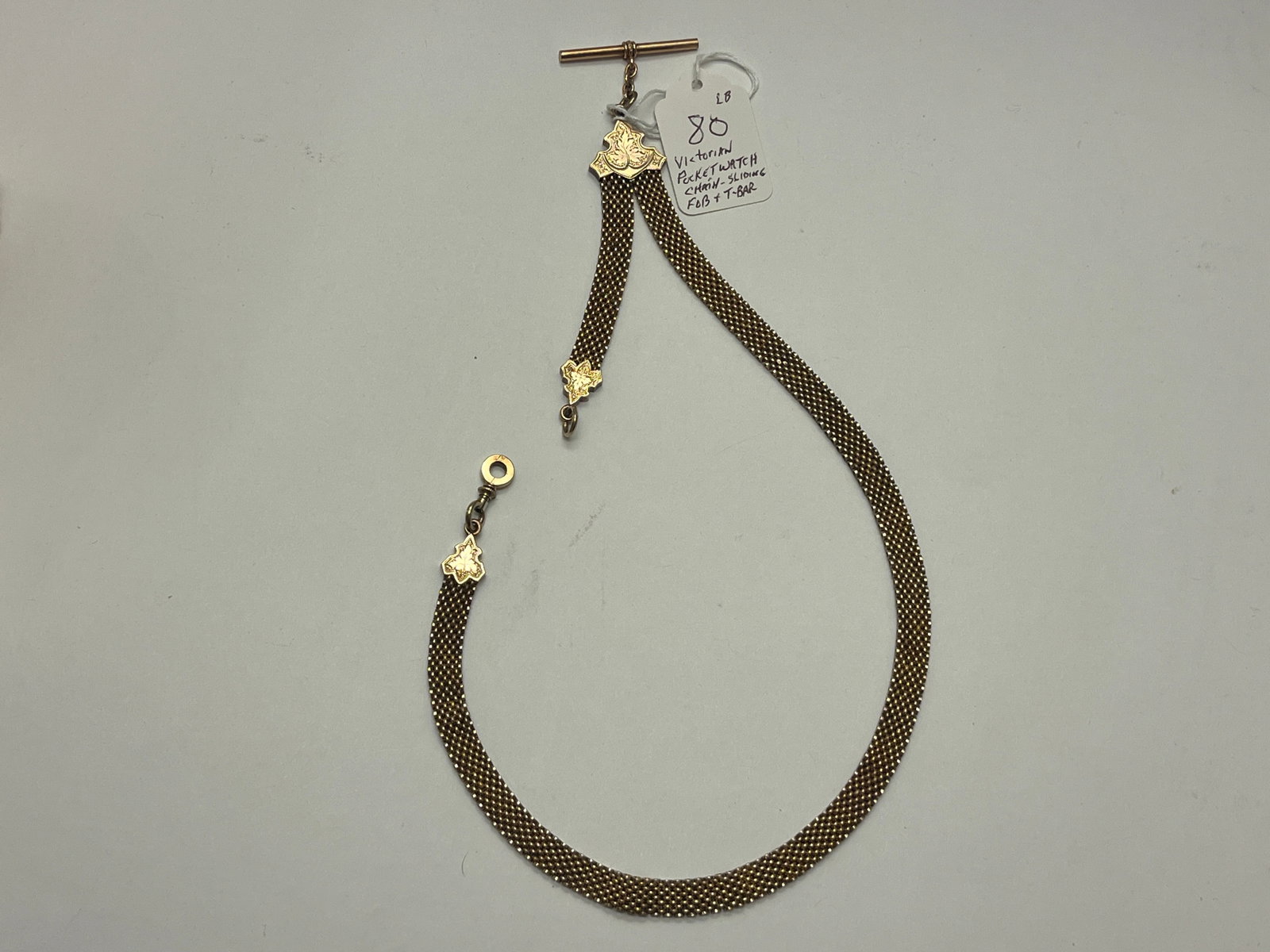 Victorian Gold Mesh Pocket Watch Chain Fob with Swivel Hook & T-Bar: Late Victorian gentleman's pocket watch chain featuring a woven mesh (book chain) design with engraved ivy leaf connectors, original T-bar, and adjustable sliding fob ring. The chain displays attracti