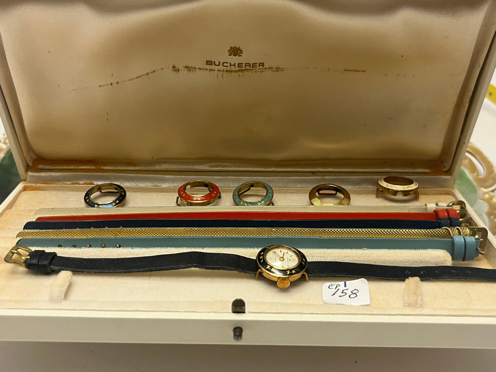 Bucherer Interchangeable Wristwatch Set – 17-Jewels Swiss, with Straps & Bezels: Vintage Bucherer ladies’ wristwatch set, Swiss made, featuring a 17-jewel mechanical movement and interchangeable bezels and straps. The set includes one gold-tone wristwatch with white dial and bla