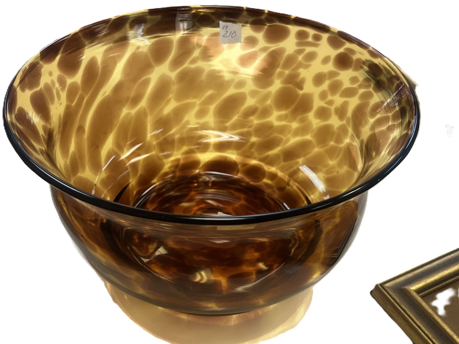 Hand-Blown Tortoiseshell Art Glass Bowl, 5.25inH?9.5in.Dia: Striking hand?blown art glass bowl in warm amber tones with mottled tortoiseshell patterning throughout. The flared rim and rounded body display excellent optical depth and light diffusion, creating a