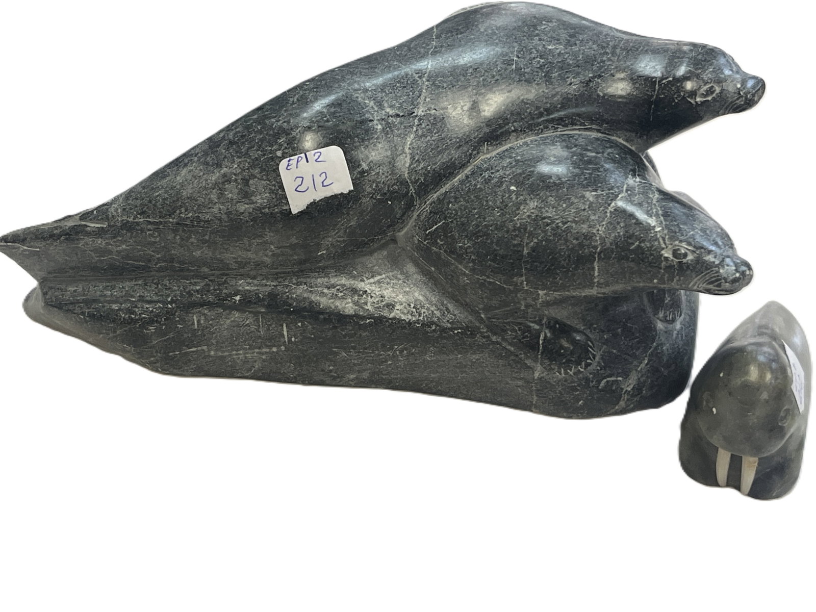 Vintage Canadian Inuit Carved Stone Seal Family & Walrus Sculptures, Seal Group 3.25"H x 8.5"W x 6"D: Vintage Canadian Inuit carved stone seal family sculpture accompanied by a separate carved stone walrus figure. The larger carving depicts a group of seals in a streamlined composition and measures ap