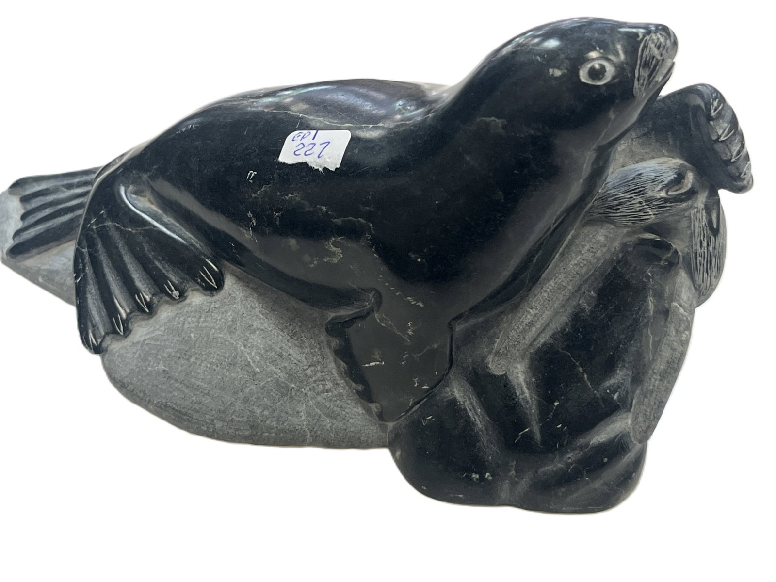 THOMASSIE TOOK INUIT SOAPSTONE SEAL SCULPTURE ? 4?H ??7.5?W ??3.5?D Marble Seal Sculpture: Hand?carved soapstone sculpture depicting a seal resting on a rock, signed Thomassie Took and numbered 211973 on underside. Includes original Canadian Inuit Art authenticity label. Deep black and gray