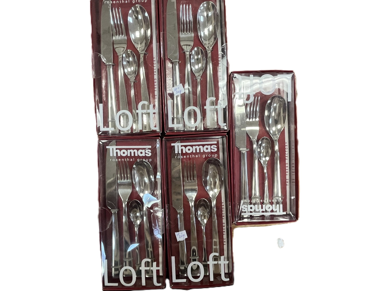 Thomas Rosenthal Group of 5 “Loft” Stainless Steel Flatware Sets: A collection of boxed Loft pattern stainless steel flatware sets by Thomas Rosenthal Group. Each set includes five pieces with sleek, modern lines and mirror?polished finish, presented in original red