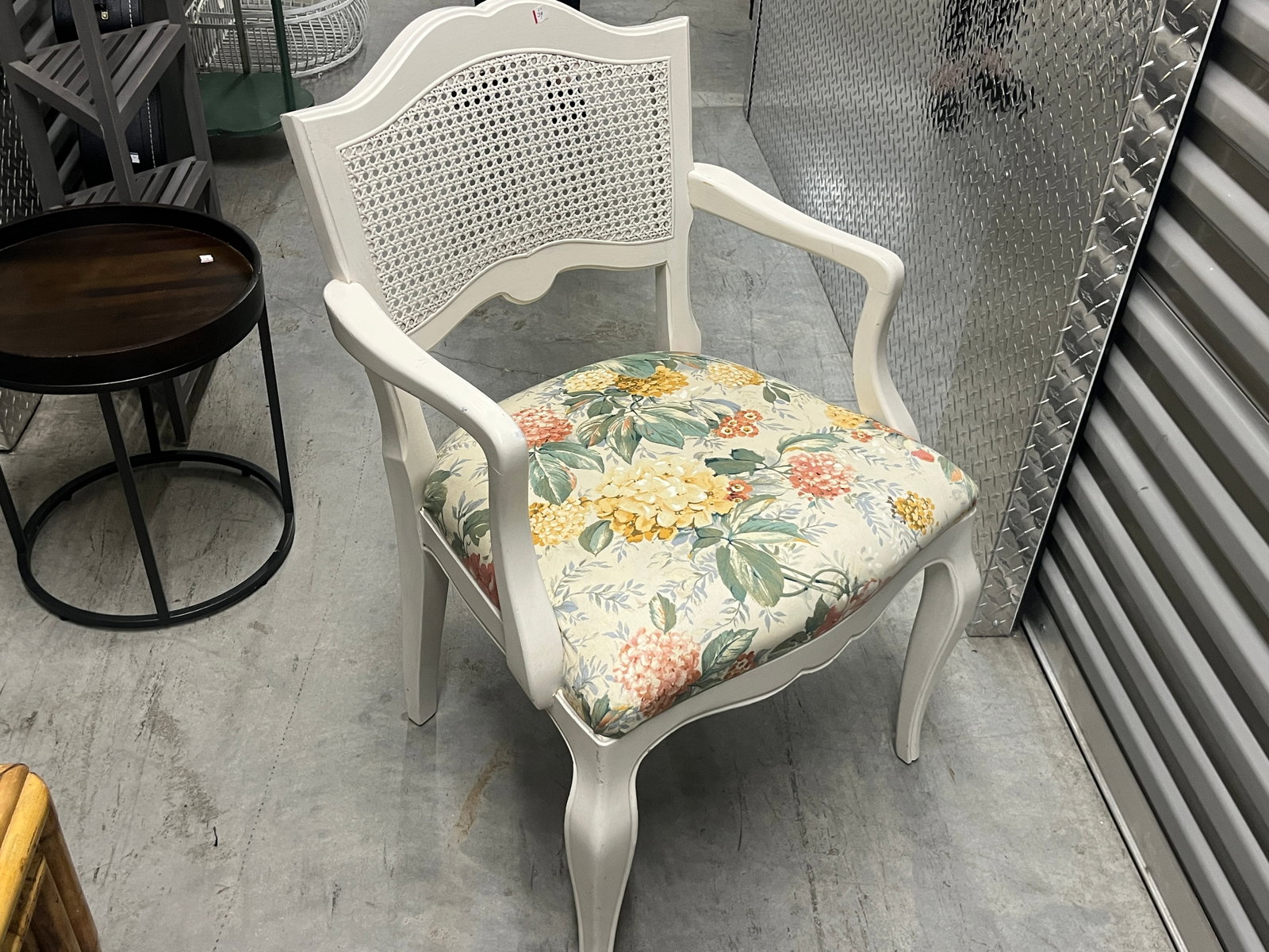 Painted Wood Cane-Back Armchair w/ Floral Upholstered Seat: Decorative wood armchair featuring a soft white painted finish, shaped crest rail, inset woven cane back, gracefully curved arms and cabriole-style front legs. Generously padded seat is upholstered in