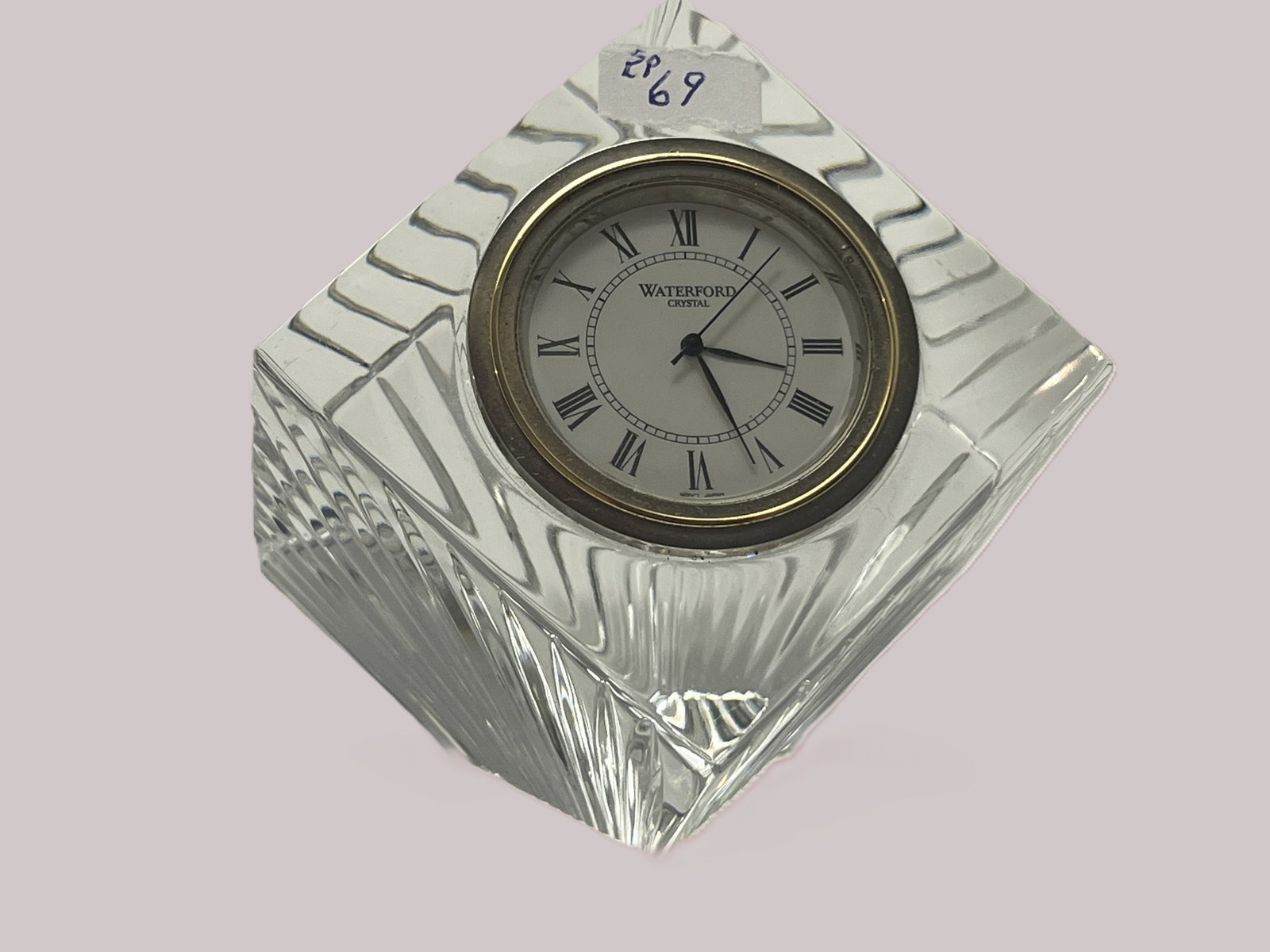 Waterford Crystal Diamond-Shaped Mantel / Desk Clock, Roman Numeral Dial: Elegant Waterford Crystal tabletop clock crafted in a substantial diamond-shaped clear crystal case with deeply cut fan and linear decoration. Features a round Waterford Crystal clock face with black 