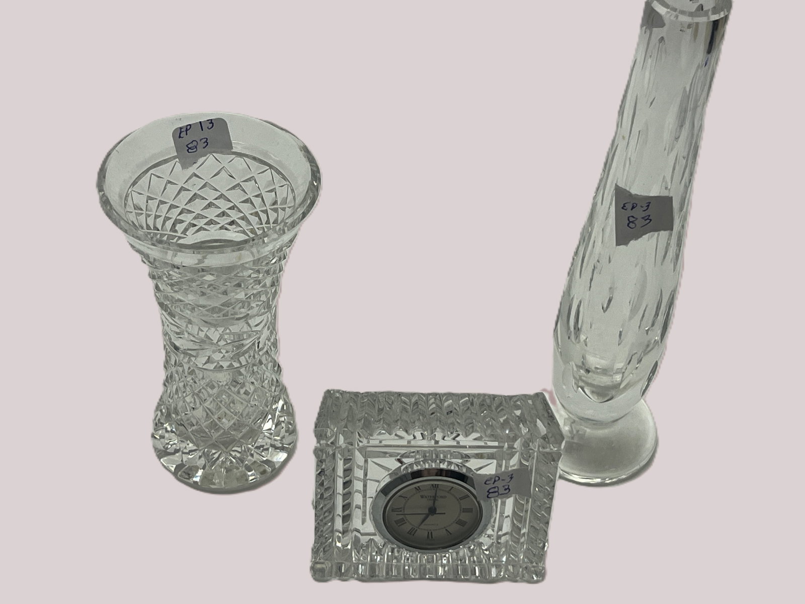 3-Pc Waterford Crystal Lot ? Clock & 2 Vases, Tallest 7"H: Three-piece collection of Waterford Crystal, with each piece bearing an etched Waterford signature. Lot includes a square cut-crystal quartz desk/table clock with Roman numeral dial, a traditional hea