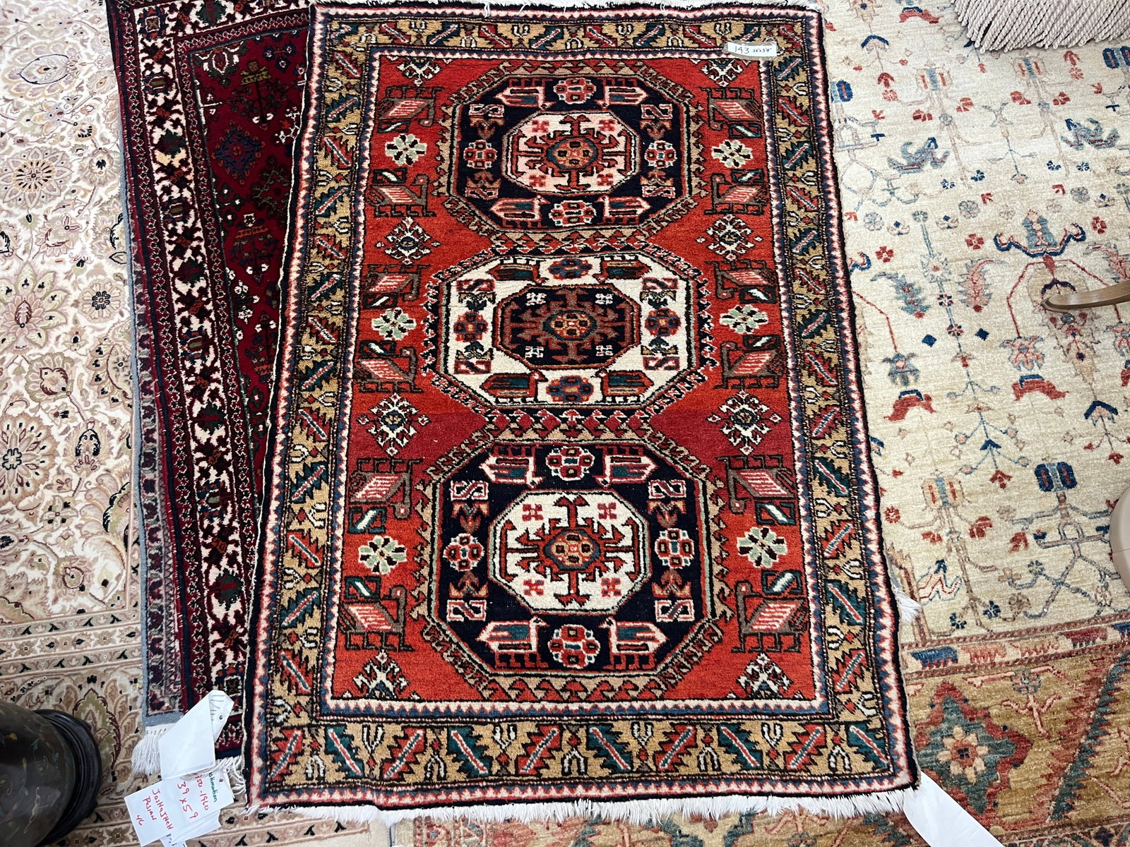 Vintage Turkish/Persian-Style Hand-Knotted Wool Rug, Approx. 3'6" x 5'4": Vintage hand-knotted wool area rug featuring a bold red field with three prominent geometric medallions, surrounded by angular tribal devices and stylized floral and geometric motifs. The composition 