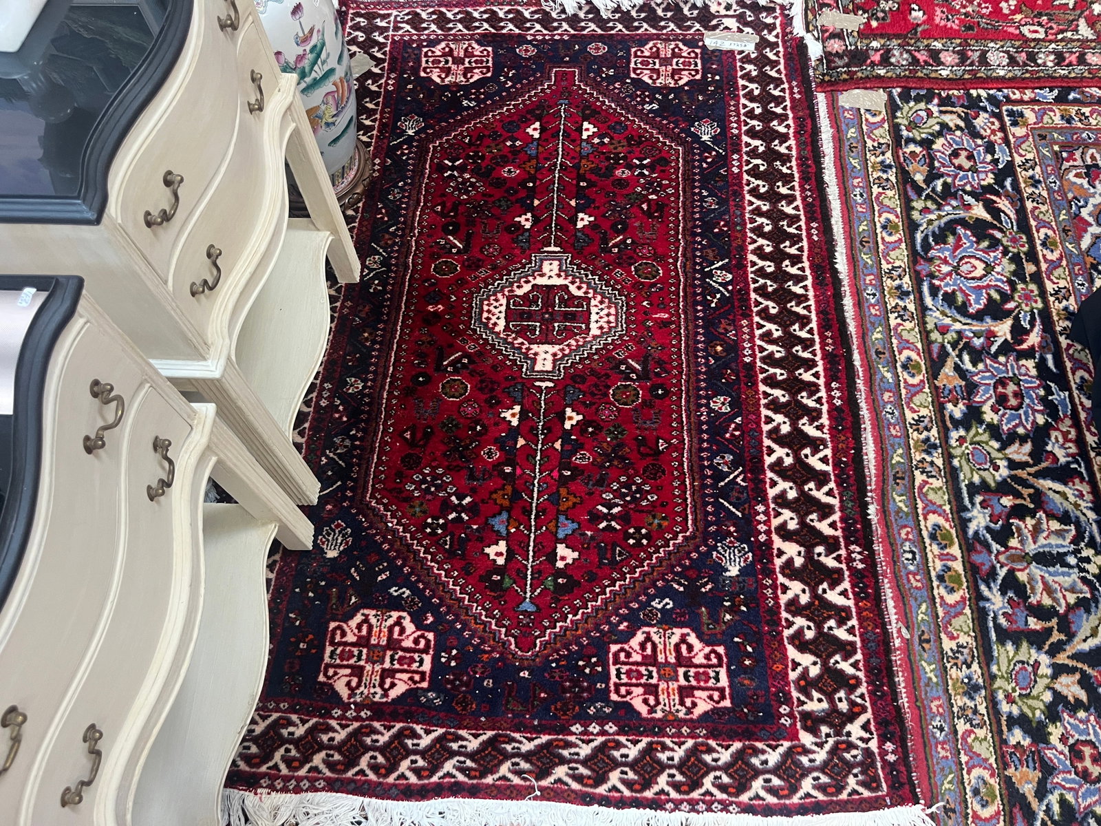 Vintage Persian Tribal Hand-Knotted Wool Rug, Approx. 3'7" x 5'8": Vintage hand-knotted wool area rug featuring a rich red field with a large elongated geometric central medallion, smaller central device, stylized floral and tribal motifs, and contrasting dark blue, 