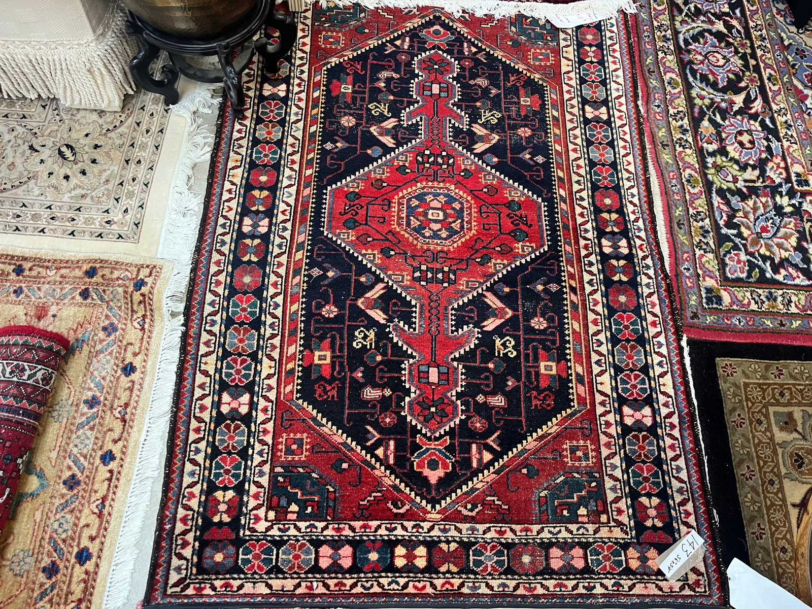 Vintage Hamedan Persian Hand-Knotted Wool Rug, Approx. 3'6" x 5'4": Vintage hand-knotted Persian wool area rug attributed to the Hamedan region of Iran, featuring a bold geometric composition with a large red central medallion against a deep navy/black field. The fiel