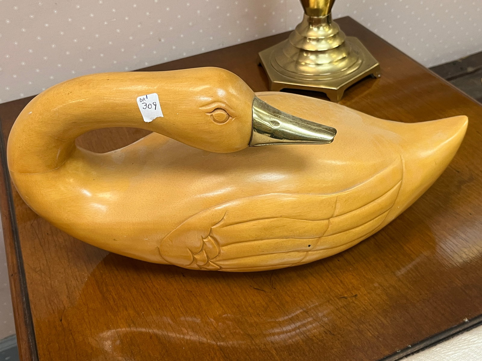Hand-Crafted Carved Wood Swan Decorative Sculpture with Brass Beak, 17" W: Large hand-crafted decorative swan sculpture carved from wood with a warm natural finish. Features a long gracefully curved neck, carved eye and wing details, and a polished brass-tone metal beak that