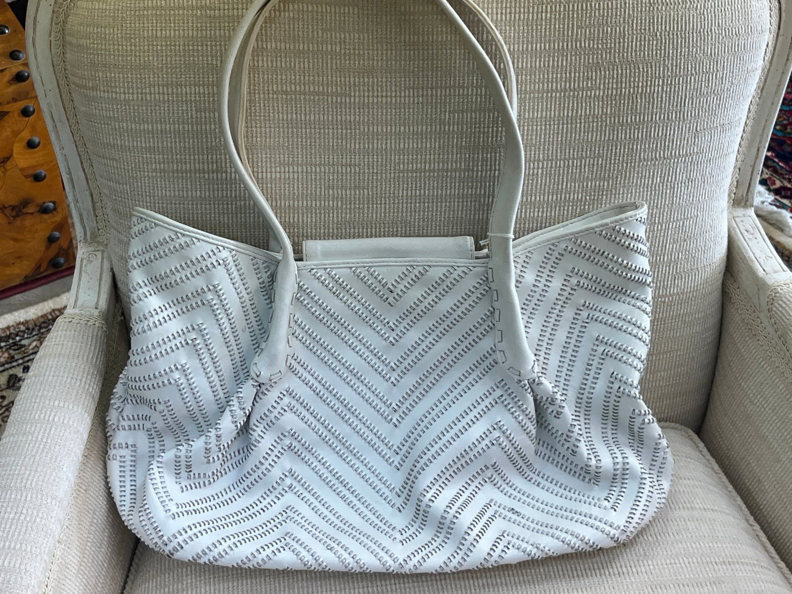 Sondra Roberts White Woven Leather Shoulder Tote Handbag: Stylish Sondra Roberts women's shoulder tote crafted in white leather with an intricate woven/cutwork chevron pattern throughout the exterior. Features dual leather shoulder straps, softly gathered si