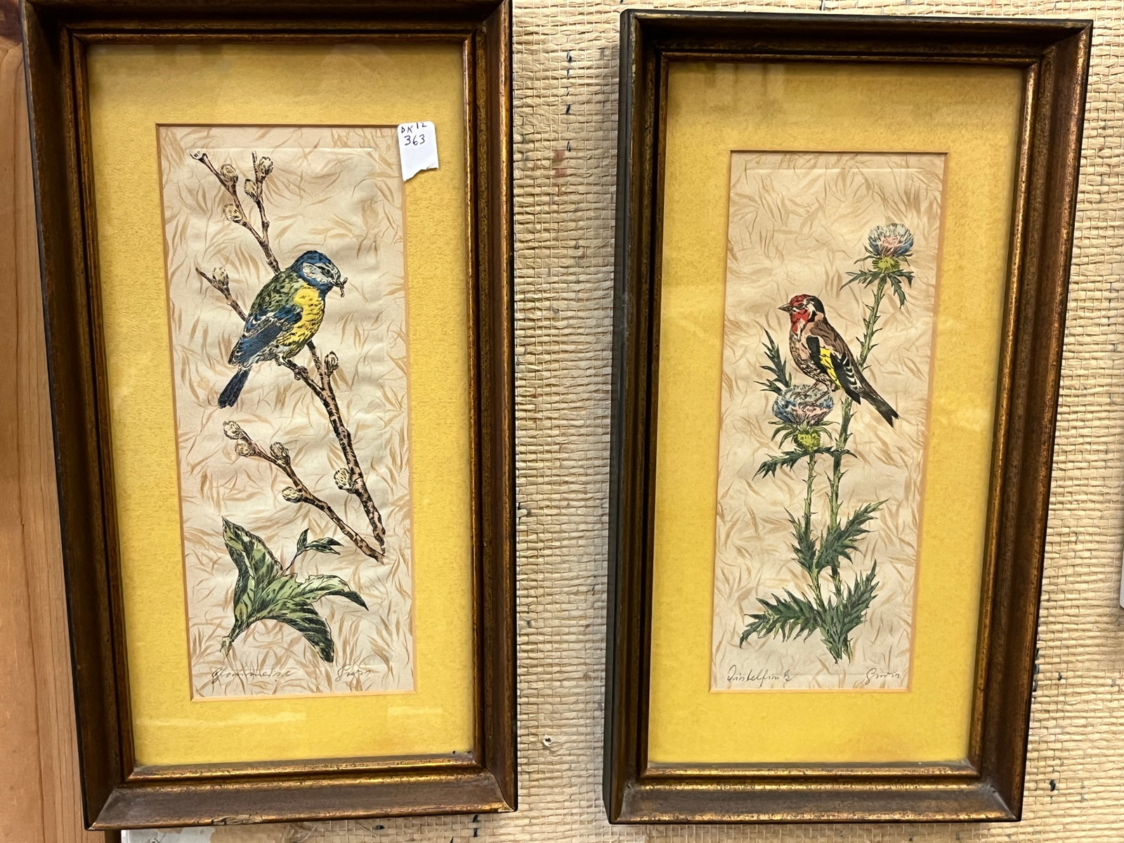 Pair VTG Signed Bird & Botanical Art on Fabric – 15.5" x 8.5": Pair of vintage decorative bird and botanical artworks executed on a textured fabric or fabric-like ground. One depicts a colorful blue and yellow songbird perched among budding branches and foliage; 