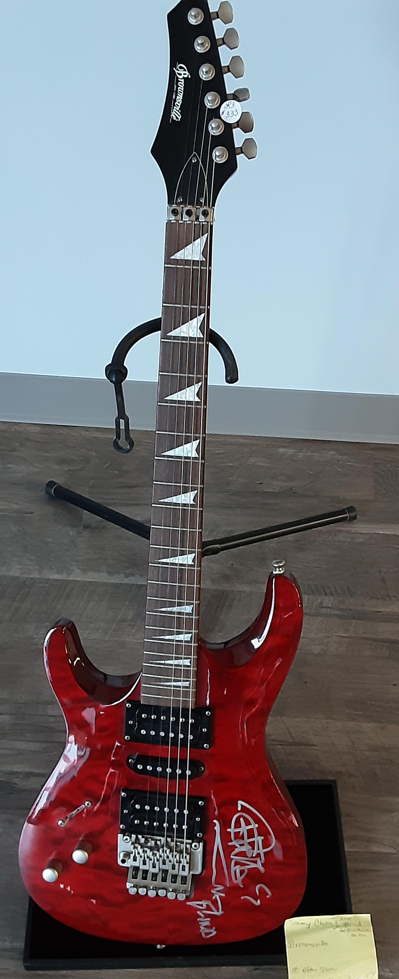 Electric guitar by Brownsville, autographed by Tommy: Beautiful cherry red electric guitar by Brownsville. Hand signed and autographed by Tommy Chong, best known for Cheech and Chong .