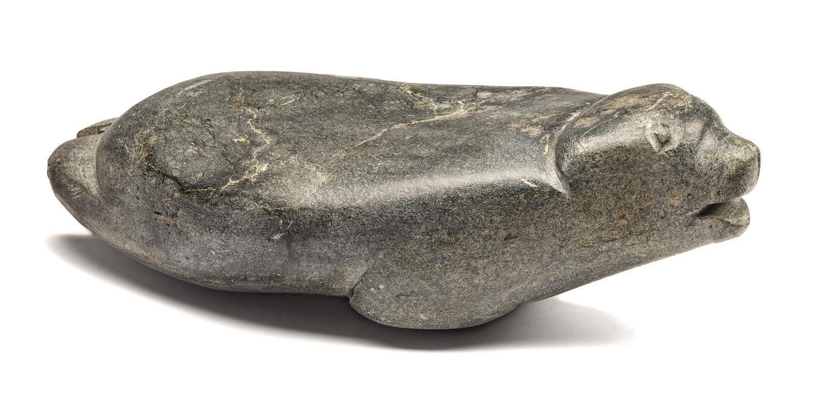 JOHN KAVIK, Seal, 1967: JOHN KAVIK (1897-1993), KANGIQLINIQ (RANKIN INLET) Seal, 1967 stone, 5.25 x 17.25 x 8.5 in (13.3 x 43.8 x 21.6 cm)