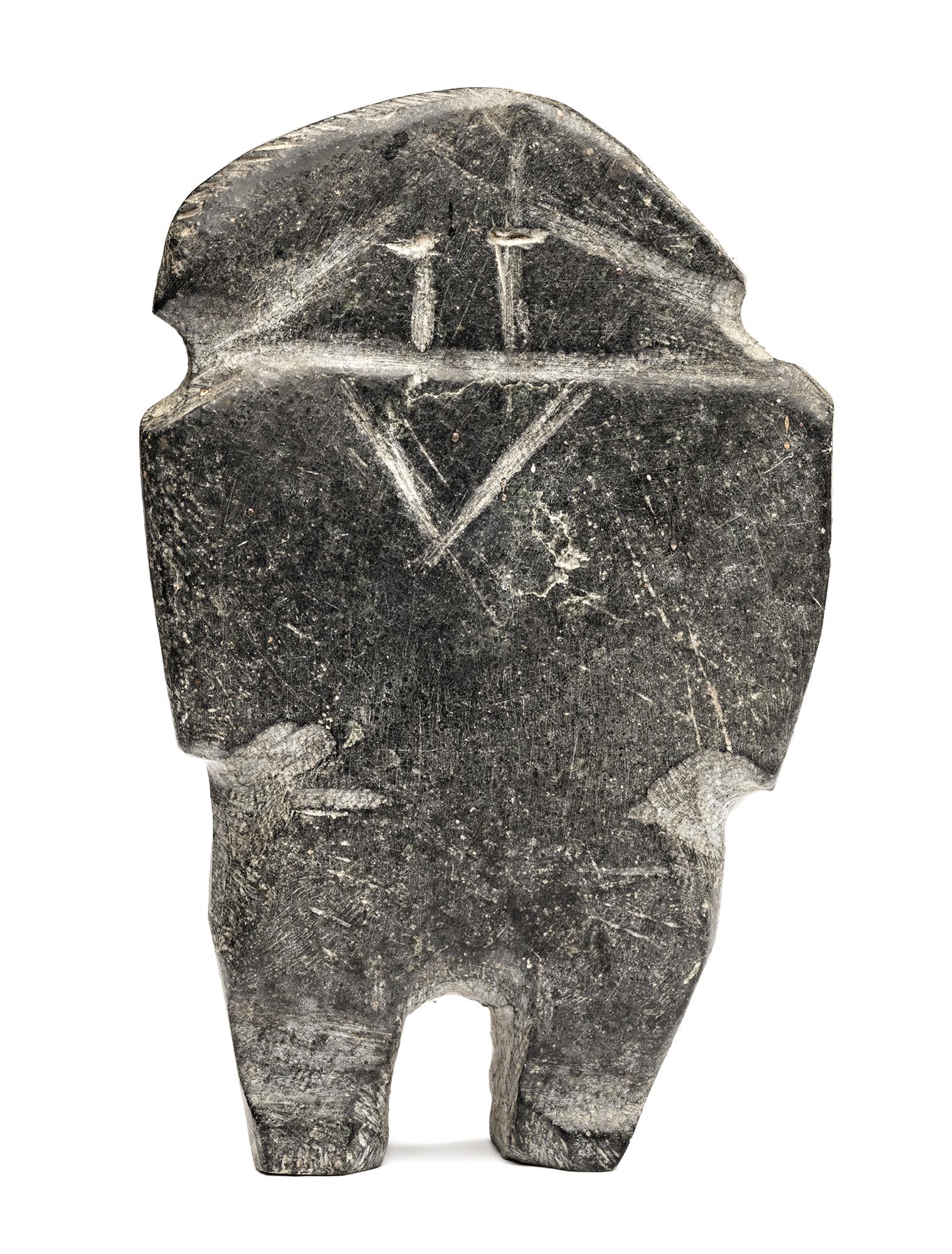 JOHN KAVIK, Inuit, Standing Figure, early-mid 1970s: JOHN KAVIK (1897-1993) KANGIQLINIQ (RANKIN INLET) Standing Figure,early-mid 1970s stone, 5.75 x 3.5 x 1 in (14.6 x 8.9 x 2.5 cm) signed, “ᑲᕕ”. Provenance Private Collec