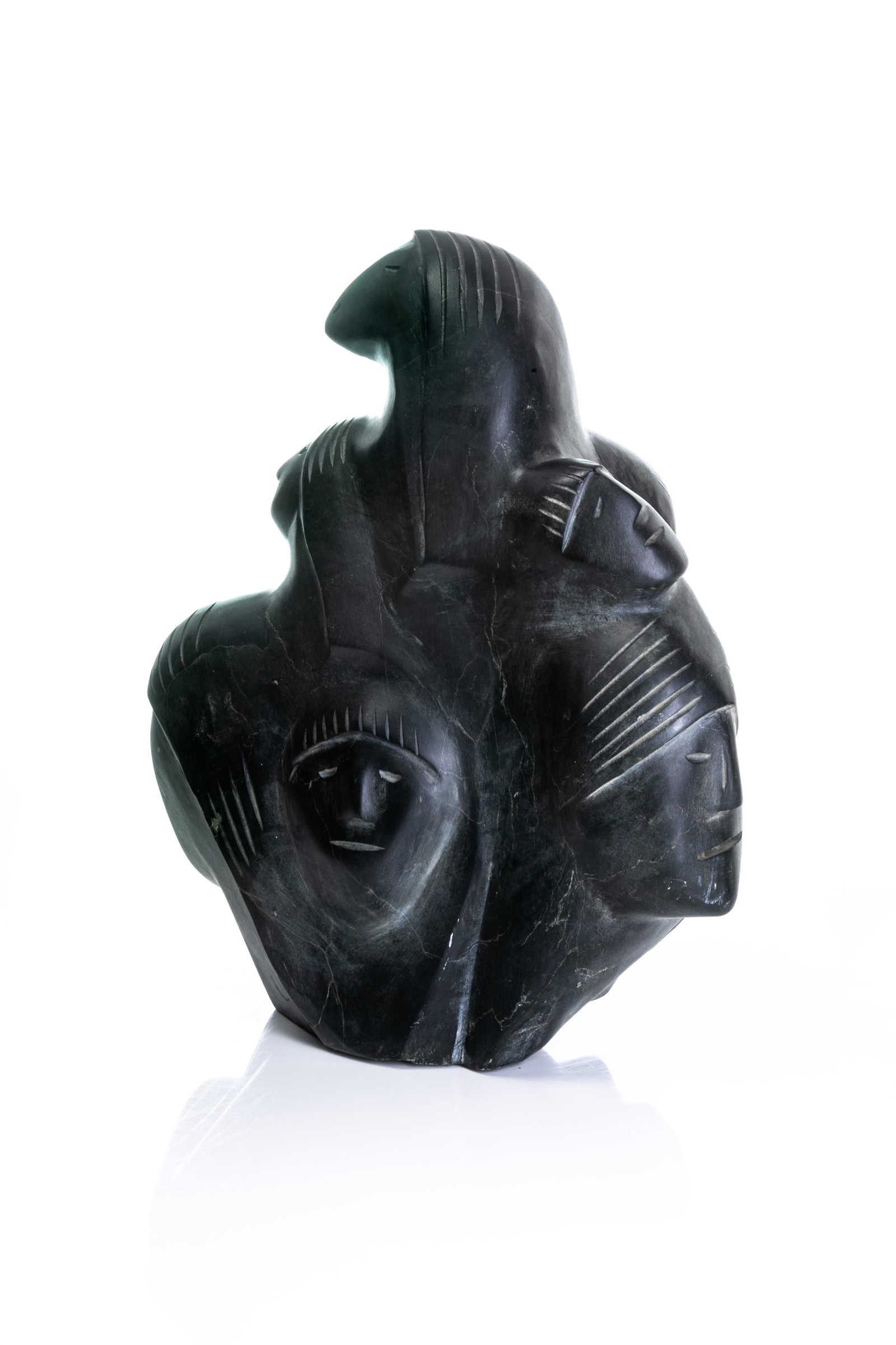 JOACHIM KAVIK, Inuit, Faces and Spirits, c. 1980s: JOACHIM KAVIK (1945-) KANGIQLINIQ (RANKIN INLET) Faces and Spirits, c. 1980s stone, 15.5 x 13 x 6 in (39.4 x 33 x 15.2 cm) signed, "ᑲᕕ". Provenance Private Collection, Ottawa.