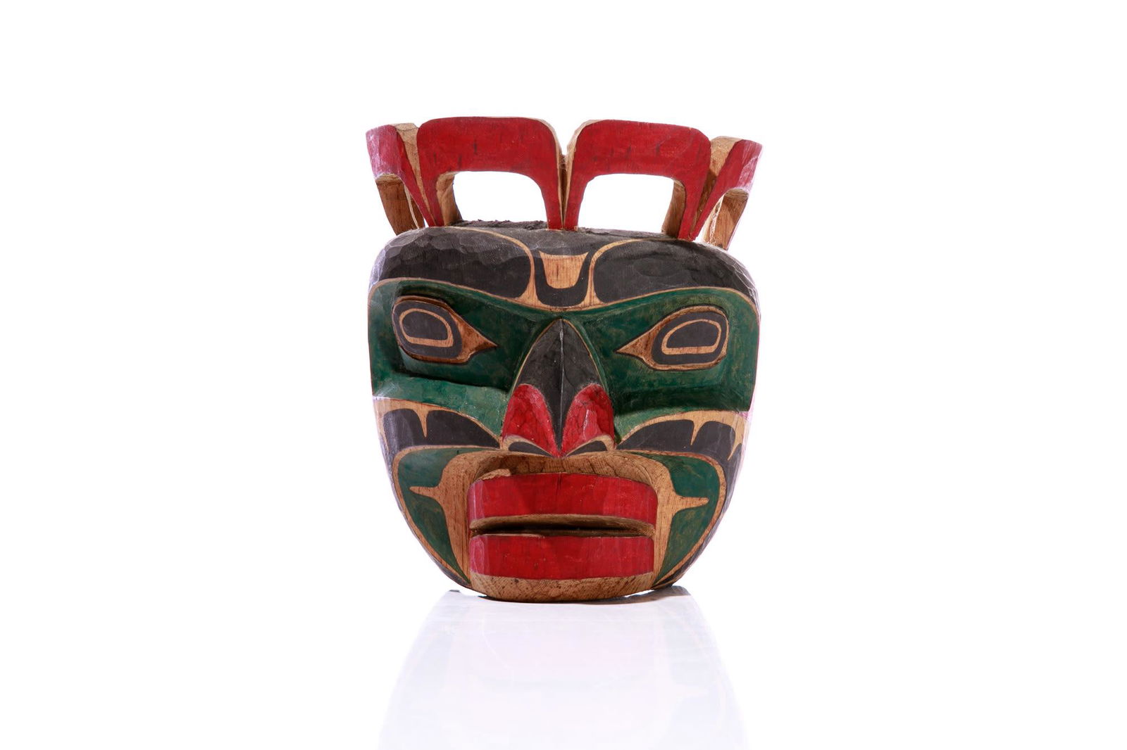 GEORGE HUNT JR. (1958-) KWAKWA̱KA̱ʼWAKW,: GEORGE HUNT JR. (1958-) KWAKWA̱KA̱ʼWAKW King of the Seal Mask, c. 1980s polychromed wood, 7 x 6 x 5.5 in (17.8 x 15.2 x 14 cm) inscribed, "KWAGIULTH / KOMOQIA / (KING of / the SEAL)". P