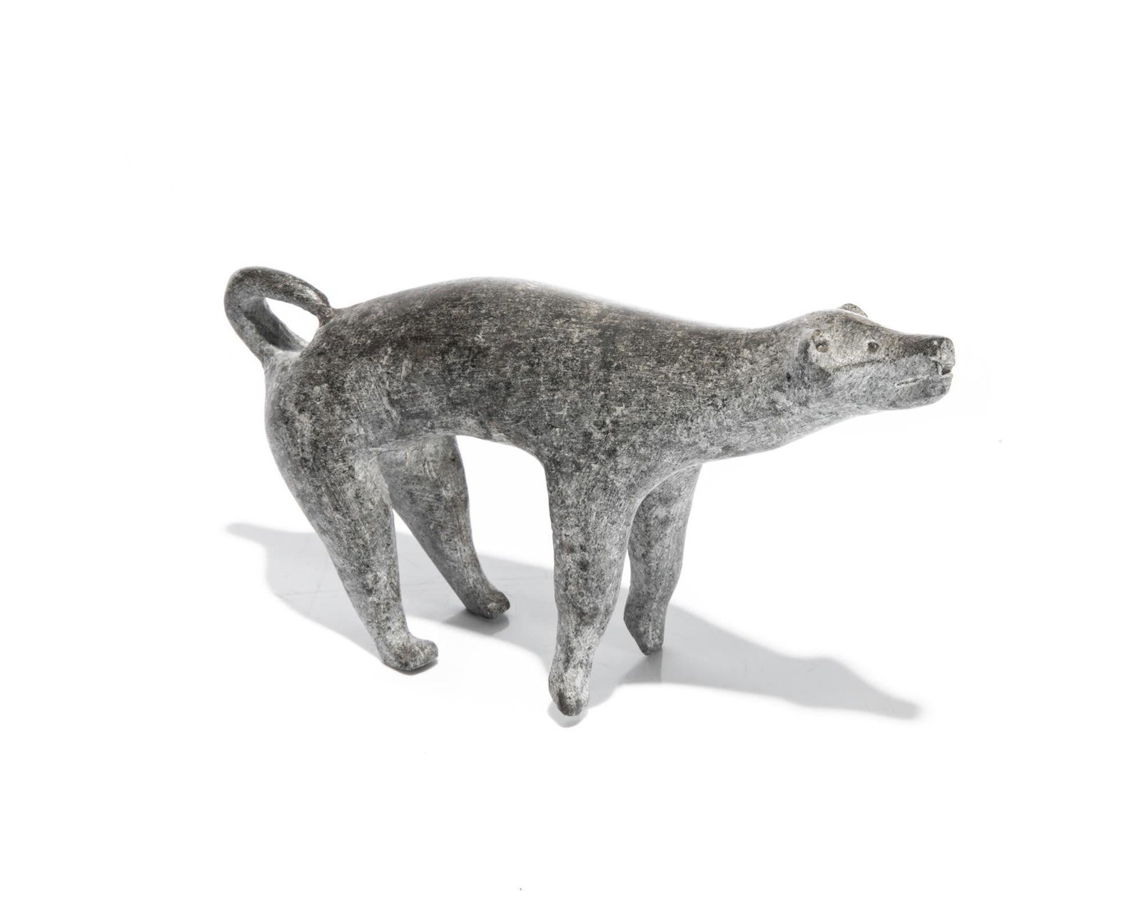 UNIDENTIFIED, Inuit, Howling Dog, c. 1955: UNIDENTIFIED ARTIST, KANGIQLINIQ (RANKIN INLET) Howling Dog, c. 1955 stone, 3 x 5.5 x 1.25 in (7.6 x 14 x 3.2 cm) unsigned. Provenance Private Collection, Toronto.