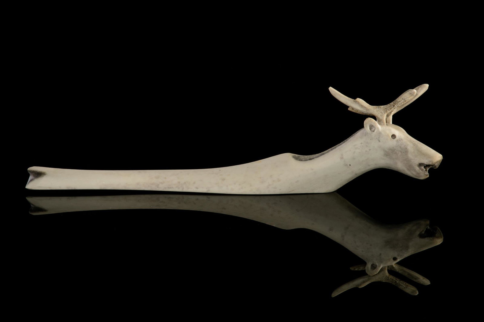 JACOB IRKOK, INUIT, Swimming Caribou, c. late 1990s: JACOB IRKOK (1937-2009) ARVIAT (ESKIMO POINT) Swimming Caribou, c. late 1990s antler, 3 x 11.5 x 2 in (7.6 x 29.2 x 5.1 cm) unsigned. Provenance A Toronto Collection.