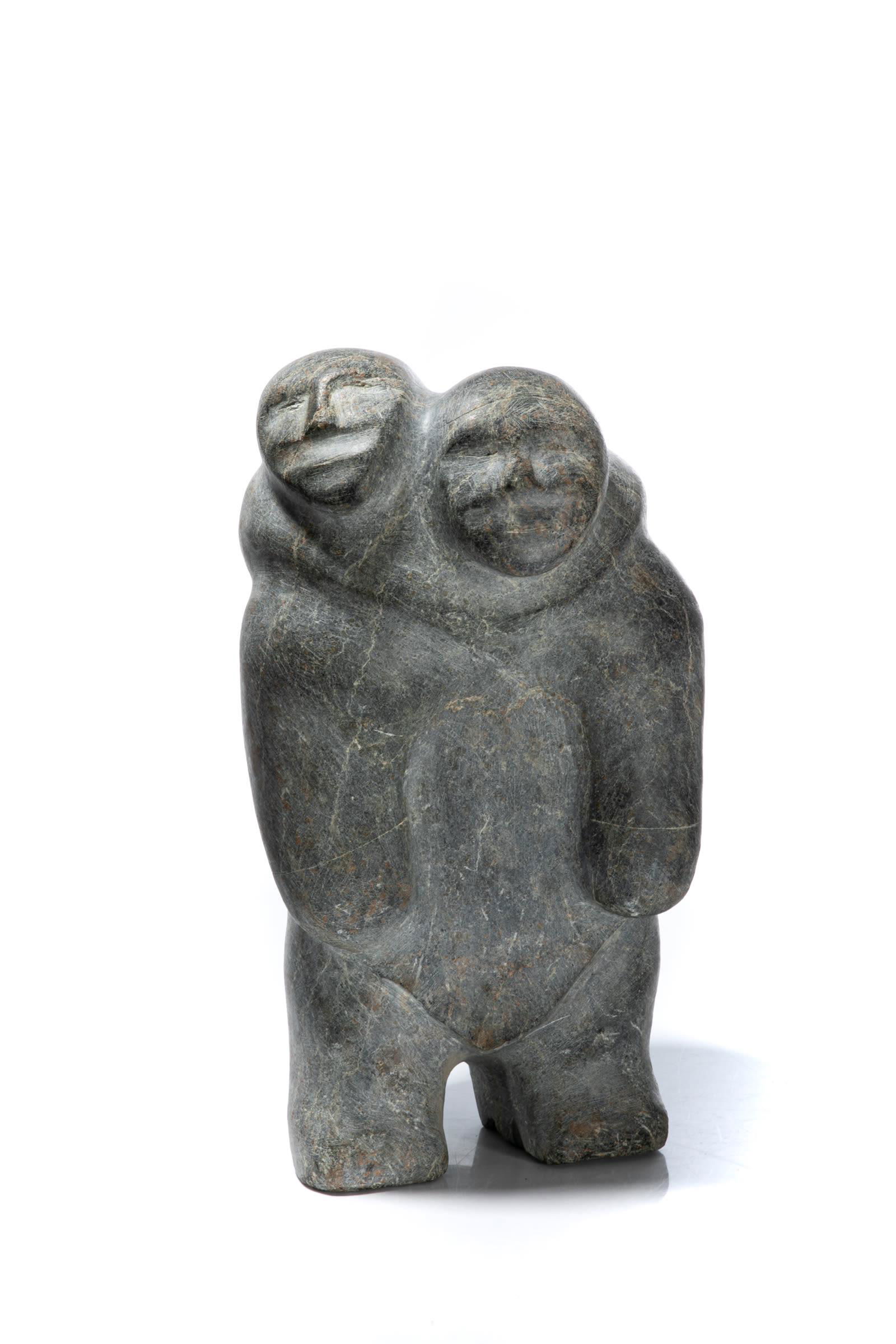 BARNABUS ARNASUNGAAQ, INUIT, Mother with Child in her: BARNABUS ARNASUNGAAQ (1924-2017) QAMANI’TUAQ (BAKER LAKE) Mother with Child in her Amaut, c. late 1980s stone, 11.25 x 6.25 x 6.25 in (28.6 x 15.9 x 15.9 cm) unsigned. Provenance A Toronto Co