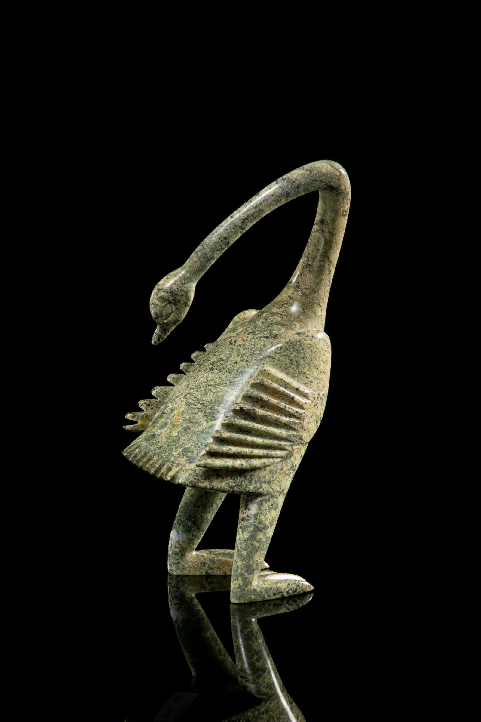 LUKTA QIATSUK, INUIT, Preening Goose, 1980s: LUKTA QIATSUK (1928-2004) KINNGAIT (CAPE DORSET) Preening Goose, 1980s stone, 9.25 x 4.75 x 3 in (23.5 x 12.1 x 7.6 cm) signed, "ᓗᑕ ᑭᐊᓯ". Provenance Private Collection, M