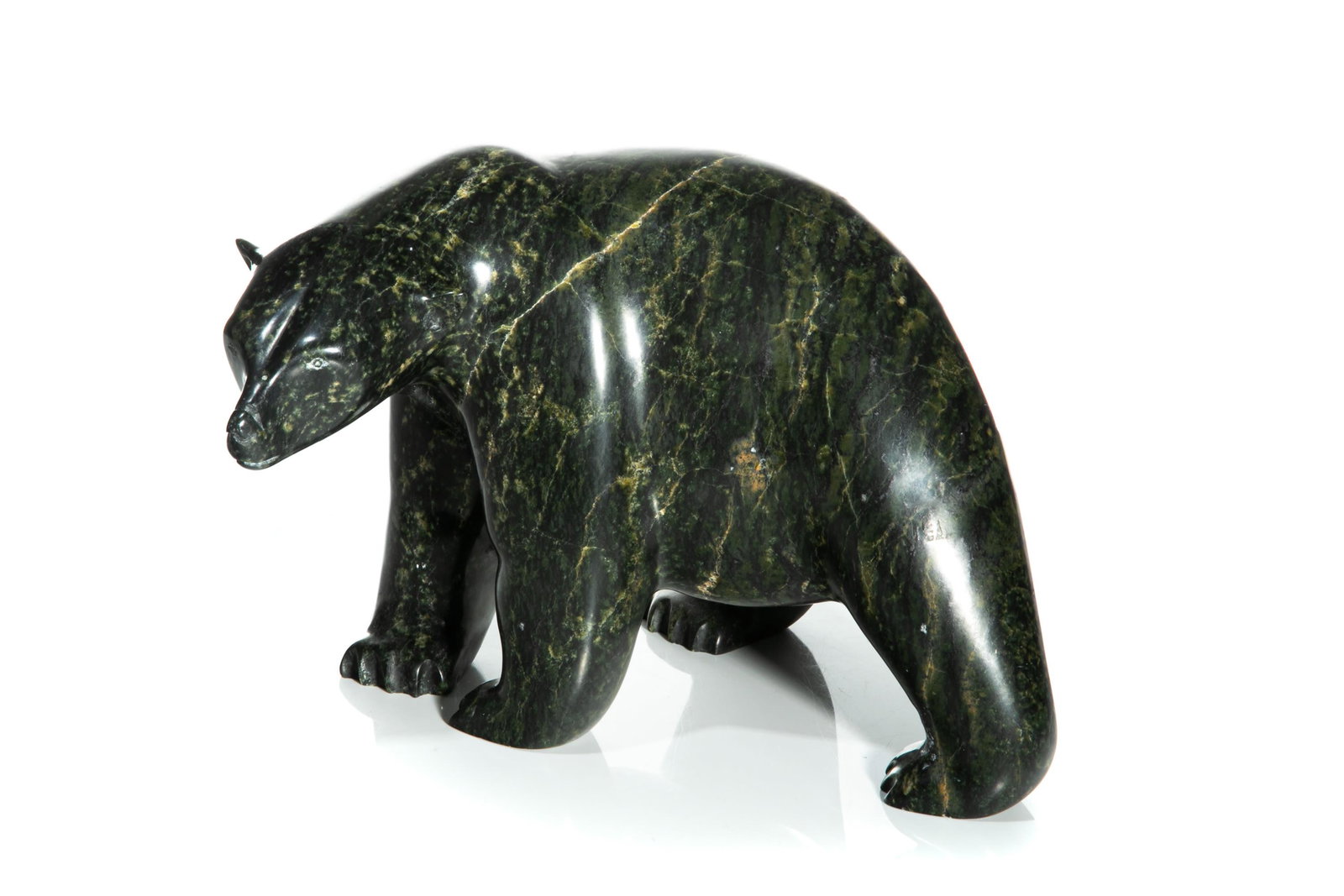 ASHEVAK TUNNILLIE, INUIT, Prowling Bear, 2004: ASHEVAK TUNNILLIE (1956-2018) KINNGAIT (CAPE DORSET) Prowling Bear, 2004 stone, 7 x 10 x 8.25 in (17.8 x 25.4 x 21 cm) signed, "ᐊᓯᕙ / ᑐᓂᓕ". Provenance Spirit Wrestl