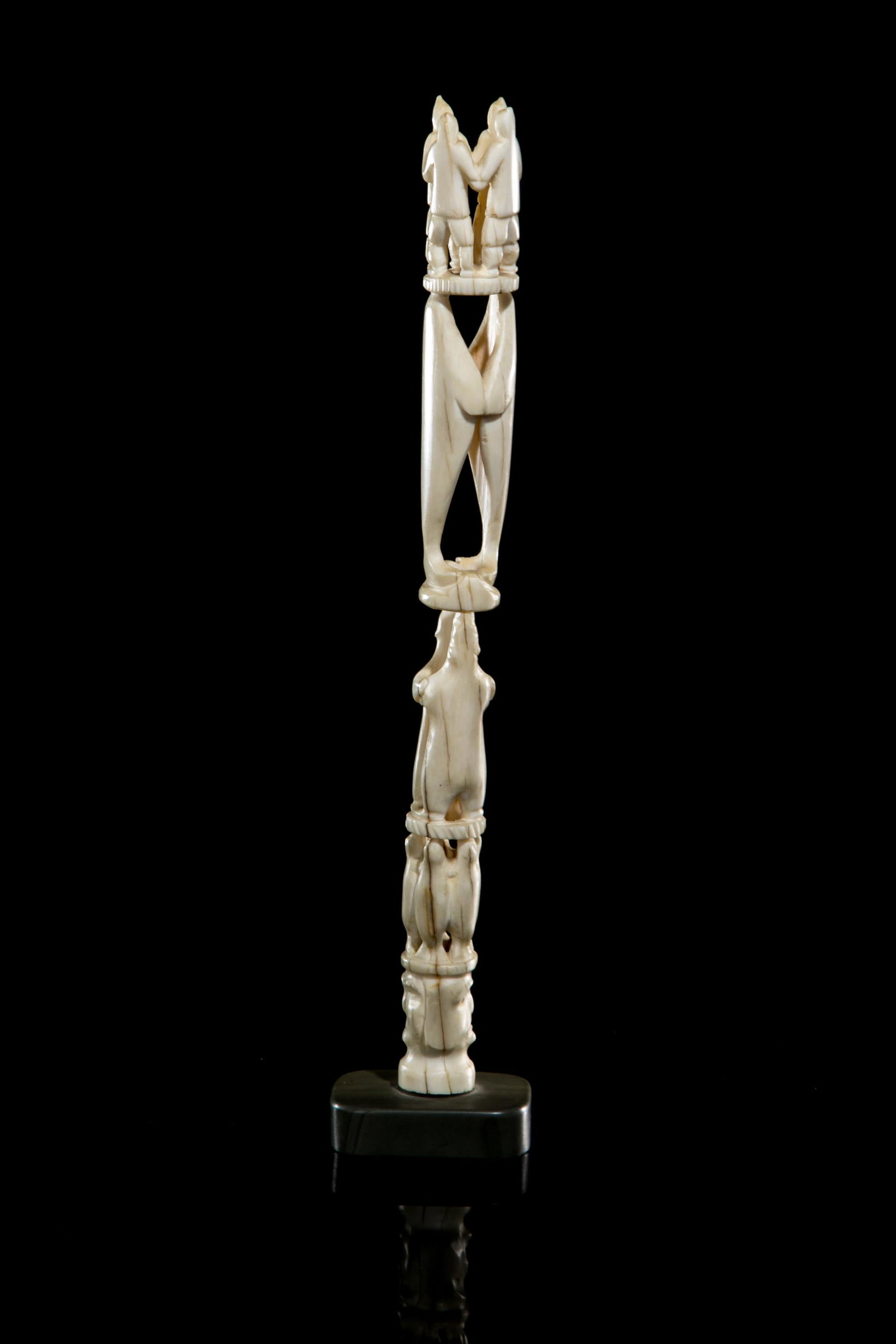 ZEBEDEE ENOOGOO, Totemic Composition with Figures and Animals, 1980s: ZEBEDEE ENOOGOO (1931-) IKPIARJUK (ARCTIC BAY) Totemic Composition with Figures and Animals, 1980s tusk and stone, 10.5 x 2 x 1.5 in (26.7 x 5.1 x 3.8 cm) signed, inscribed with disc number, and furth