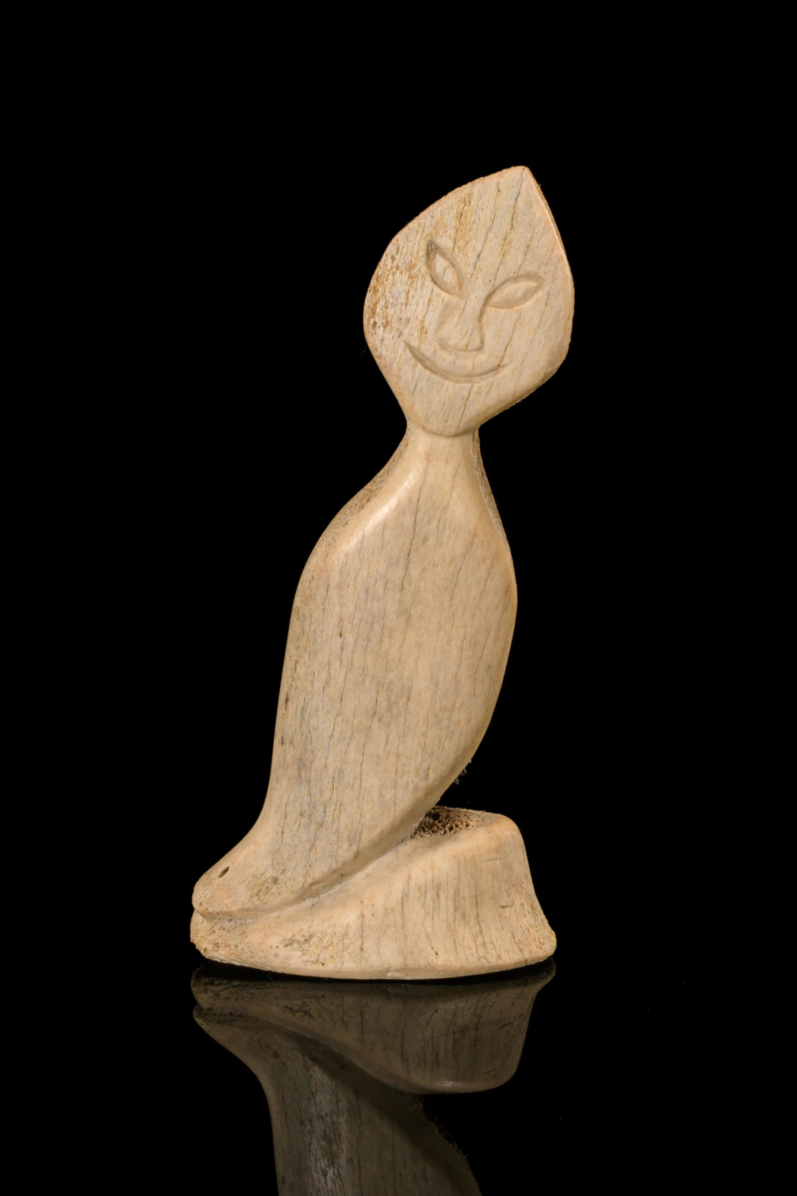 NUTARALAQ AKULUKJUK, INUIT, Grinning Spirit Figure, early 1970s: NUTARALAQ AKULUKJUK (1916-D) PANNIRTUQ (PANGNIRTUNG) Grinning Spirit Figure, early 1970s whalebone, 12.25 x 5.75 x 3.5 in (31.1 x 14.6 x 8.9 cm) given to the artist on the affixed igloo tag. Provenanc