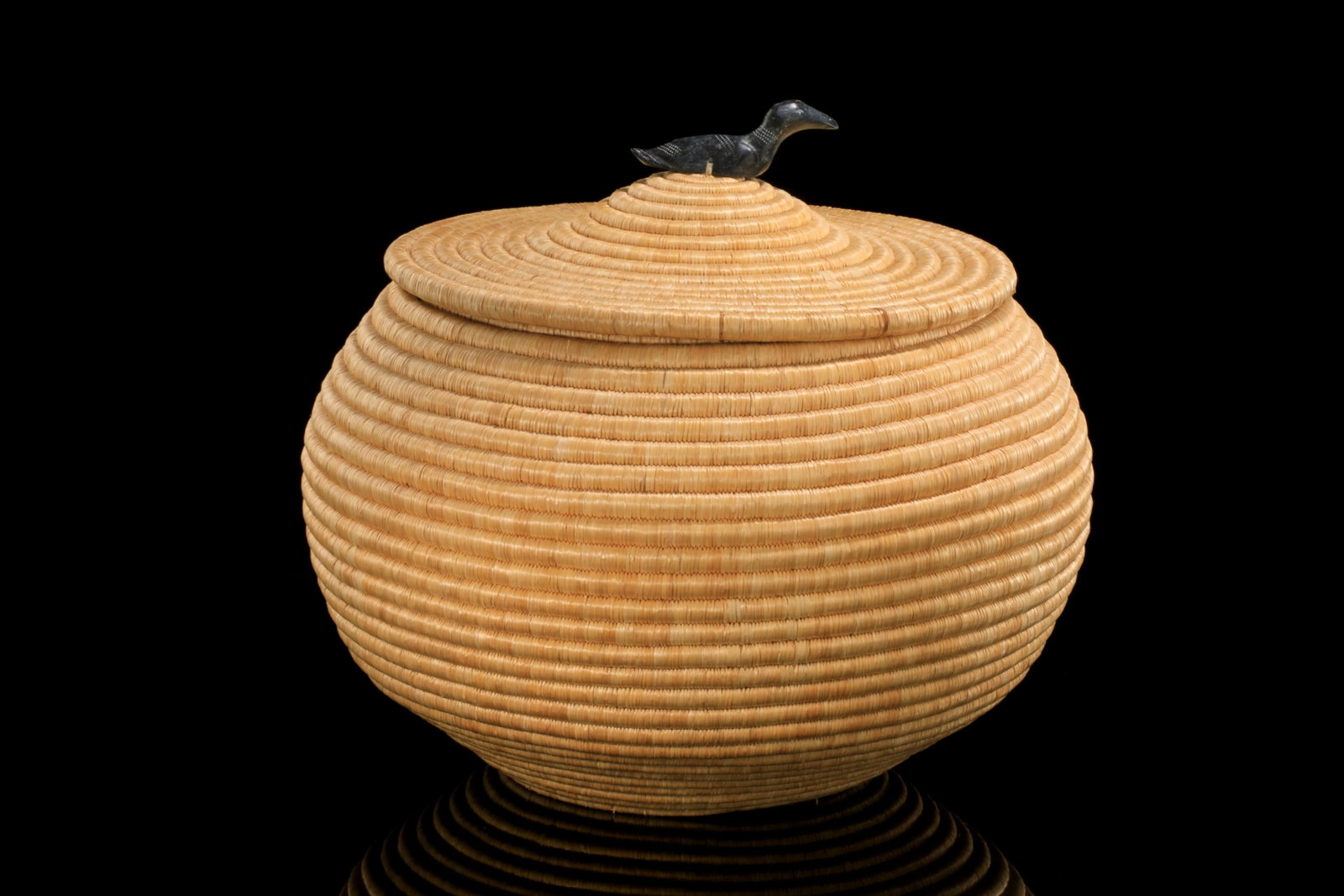 ELIZABETH ESPERUN, INUIT, Large Basket with Loon Top Knot, 1970s: ELIZABETH ESPERUN, KUUJJUARAPIK (GREAT WHALE RIVER) Large Basket with Loon Top Knot, 1970s wove and coiled grass, stone, hide, and waxed string 16 x 20 x 20 in (40.6 x 50.8 x 50.8 cm) given to the art