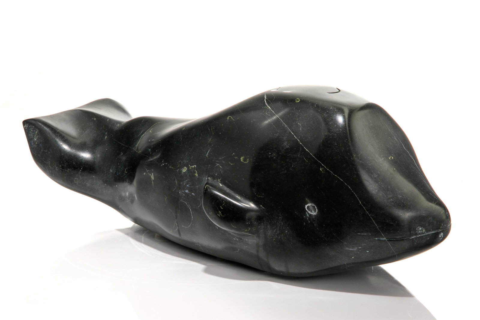 PAULOOSE AHRNNKVINA, INUIT, Whale, 1970s: PAULOOSE AHRNNKVINA, QIKIQTAALUK (NORTH BAFFIN), Probably PANNIQTUUQ (PANGNIRTUNG) Whale, 1970s stone, 7 x 17.5 x 7.5 in (17.8 x 44.5 x 19.1 cm) signed, "PAULOOSE / AHRNNKVINA". Provenance Private Col