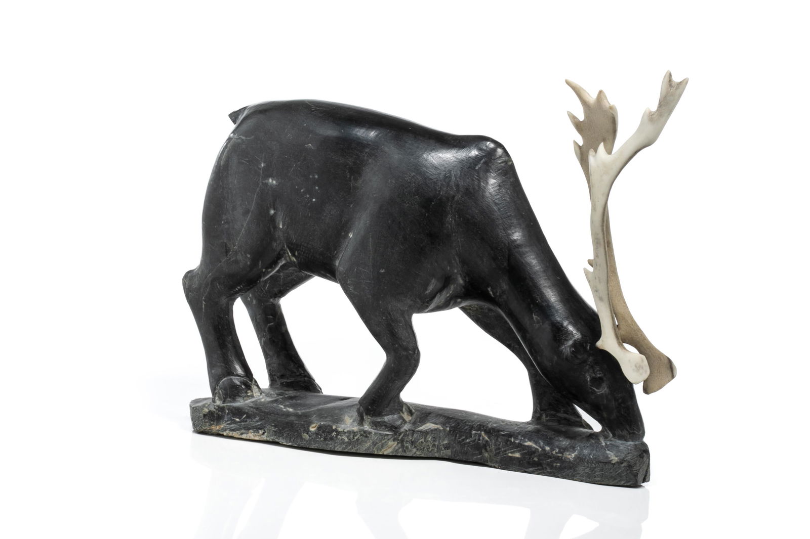 TOWATUGA SAGOUK, INUIT, Caribou Feeding, late 1960s / early 1970s: TOWATUGA SAGOUK (1934-) IQALUIT (FROBISHER BAY) Caribou Feeding, late 1960s / early 1970s stone and antler, 8.75 x 10.75 x 3 in (22.2 x 27.3 x 7.6 cm) signed and inscribed with artist's disc number, "