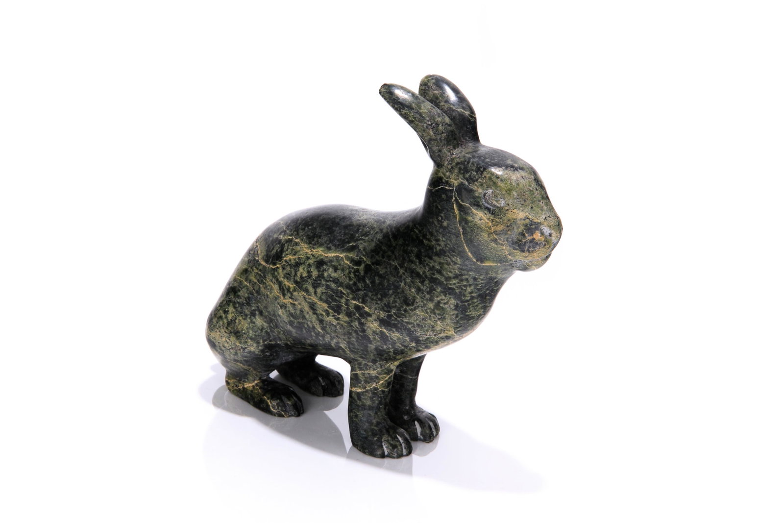 HENRY EVALUARDJUK, INUIT, Scenting Arctic Hare, mid 1980s: HENRY EVALUARDJUK (1923-2007) IQALUIT (FROBISHER BAY) Scenting Arctic Hare, mid 1980s stone, 5.5 x 5.75 x 2.5 in (14 x 14.6 x 6.3 cm) signed, "HENRY / ᐃᕙᓗ ᐊᔪ". Provenance