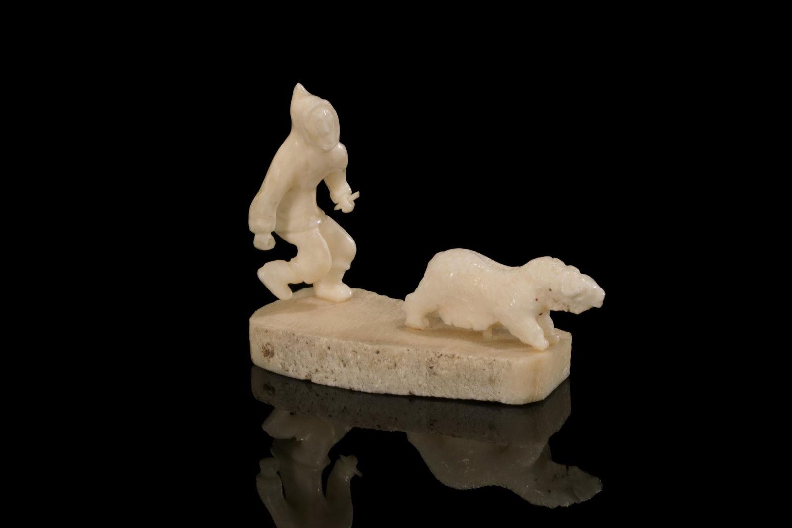 LUKE AIRUT, INUIT, Hunter in Pursuit of a Muskox: LUKE AIRUT (1942-2018) IGLULIK (IGLOOLIK) Hunter in Pursuit of a Muskox whalebone and walrus tusk, 2 x 2.5 x 1 in (5.1 x 6.3 x 2.5 cm) signed, "LUKE / AIRUT". Provenance Private Collection, Toronto. A