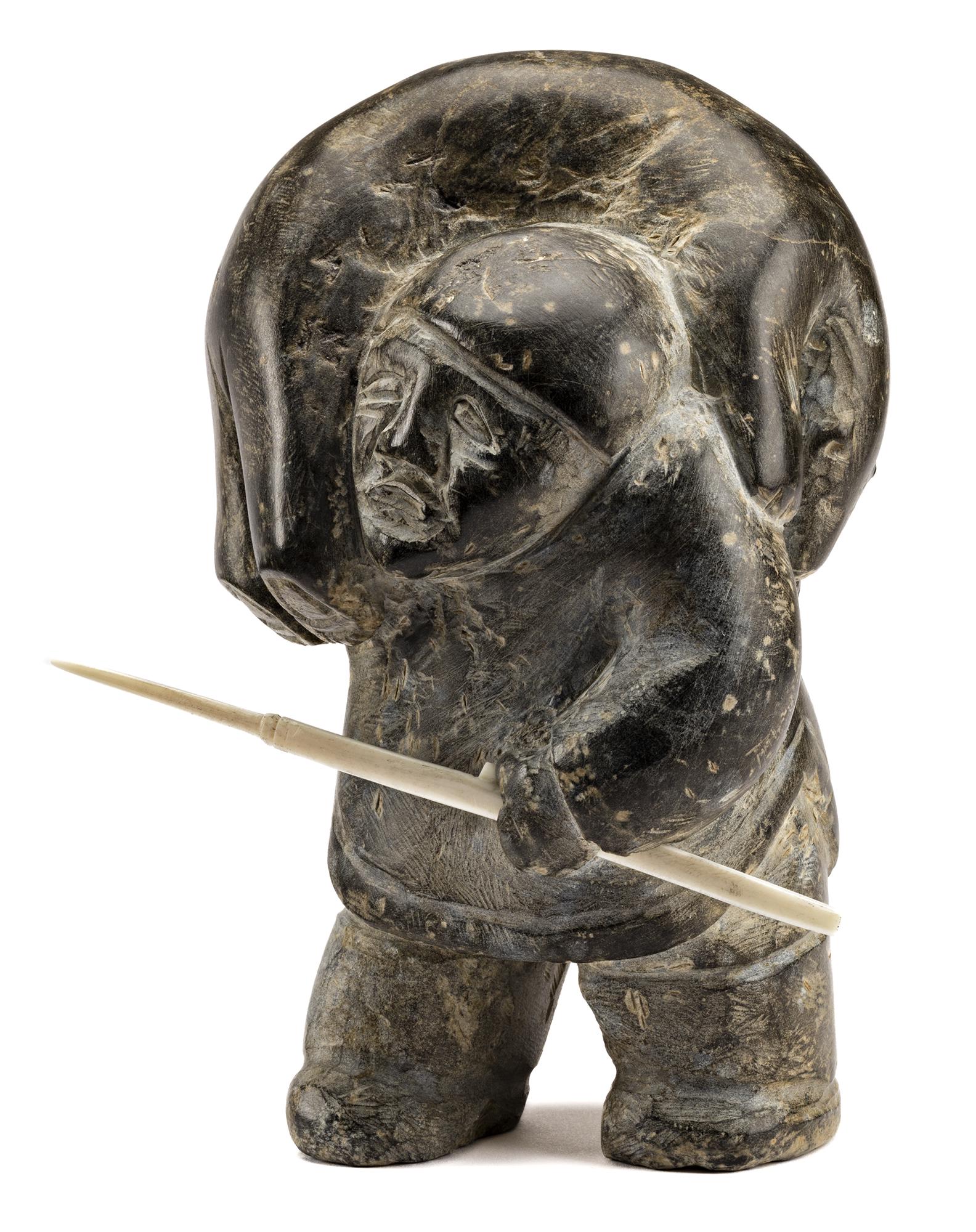 ENNUTSIAK, INUIT, Hunter with Captured Bear, c. 1960-62: Lot 124 ENNUTSIAK (1893-1967) IQALUIT (FROBISHER BAY) Hunter with Captured Bear, c. 1960-62 stone and walrus tusk, 7.75 x 5.5 x 4.25 in (19.7 x 14 x 10.8 cm), measurements reflect width without inset 