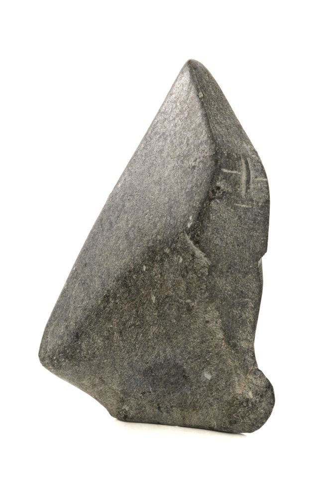 JOHN PANGNARK, INUIT, Kneeling Figure, mid 1970s: JOHN PANGNARK (1920-1980) ARVIAT (ESKIMO POINT) Kneeling Figure, mid 1970s stone, 5.25 x 3.75 x 1.5 in (13.3 x 9.5 x 3.8 cm) signed, "ᐸᓂ". Provenance Collection of John and Joyce Price, Se