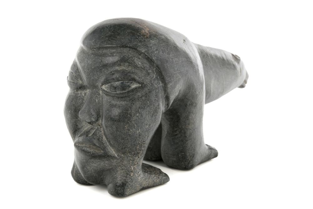 HENRY NAPARTUK, INUIT, Hunter's Thoughts of a Polar Bear, c. 1970: HENRY NAPARTUK (1932-1985) KUUJJUARAPIK (GREAT WHALE RIVER) Hunter's Thoughts of a Polar Bear, c. 1970 stone and antler, 4 x 7.5 x 2.5 in (10.2 x 19.1 x 6.3 cm) signed and inscribed with artist's disc