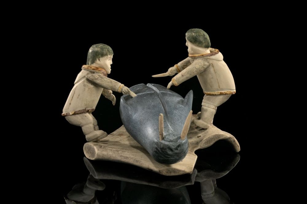 ROMEO EEKERKIK, INUIT, Two Men Flensing a Walrus, c. 1975: ROMEO EEKERKIK (1923-1983) ARVIAT (ESKIMO POINT) Two Men Flensing a Walrus, c. 1975 stone and antler, 6.25 x 9.5 x 9.75 in (15.9 x 24.1 x 24.8 cm) unsigned; accompanied by a facsimile copy of the Reco