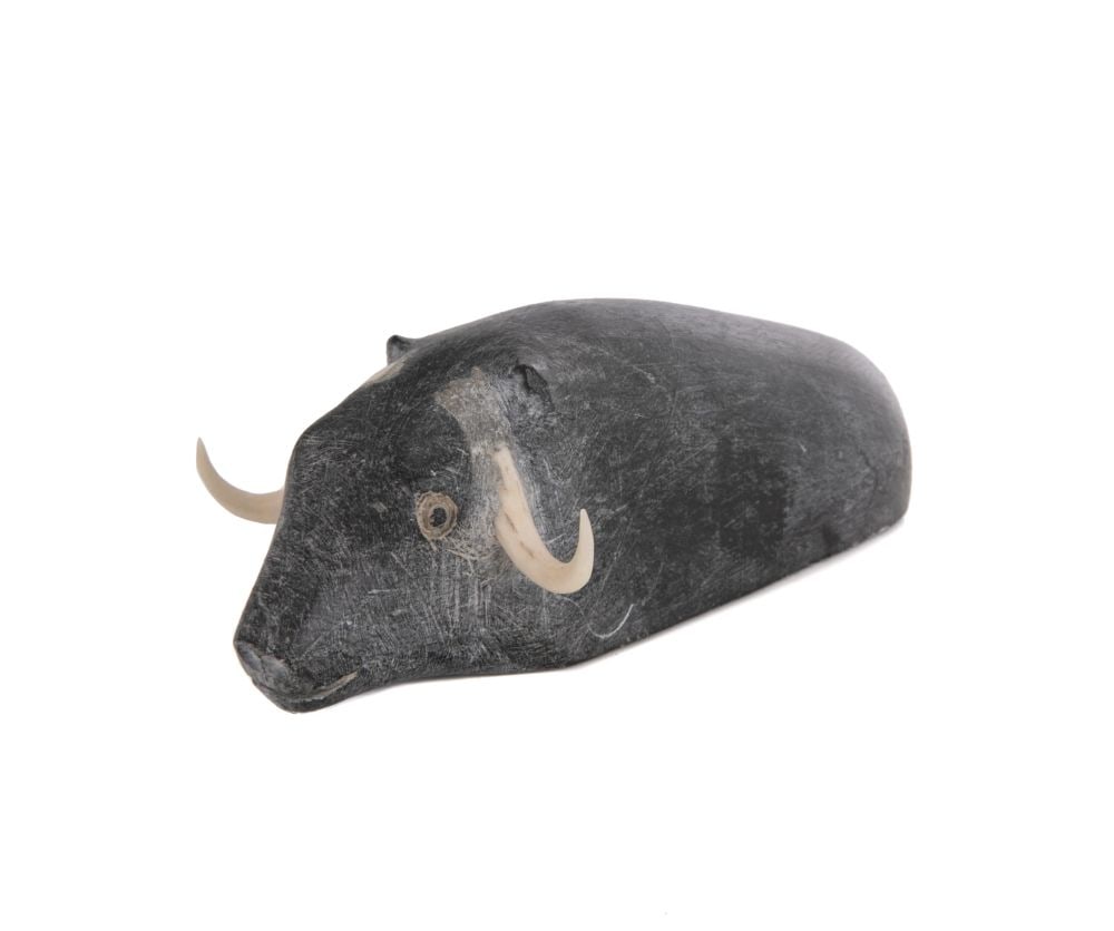 OLIVE MAMAK INNAKATSIK, INUIT, Wading Muskox, c. 1970: OLIVE MAMAK INNAKATSIK (1915-1994) QAMANI'TUAQ (BAKER LAKE) Wading Muskox, c. 1970 stone and antler, 1.5 x 4.25 x 2.25 in (3.8 x 10.8 x 5.7 cm) signed, "ᐃᓇᑲᓯ". Provenance Colle