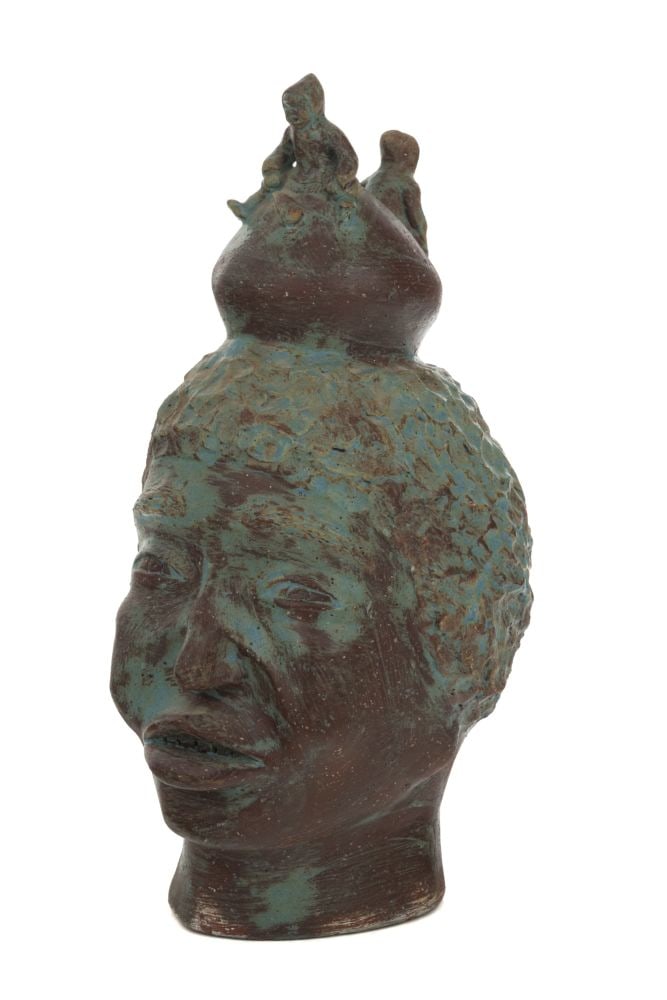 CHARLIE PANIGONIAK, INUIT, Man's Head with Inuuk, c. 1970: CHARLIE PANIGONIAK (1946-2019) KANGIQLINIQ (RANKIN INLET) Man's Head with Inuuk, c. 1970 glazed ceramic, 13 x 8.5 x 6.75 in (33 x 21.6 x 17.1 cm) inscribed with artist's disc number and signed, "E3-13