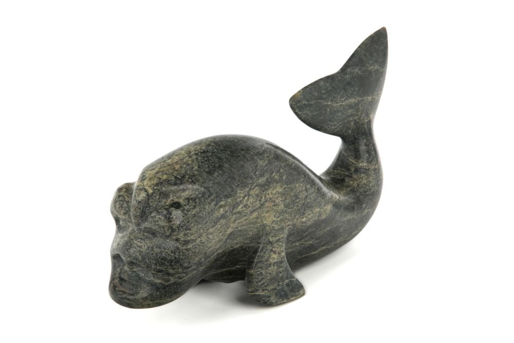 OVILOO TUNNILLIE, INUIT, Whale Spirit, 1980s: OVILOO TUNNILLIE, R.C.A. (1949-2014) KINNGAIT (CAPE DORSET) Whale Spirit, 1980s stone, 5.5 x 11 x 3.25 in (14 x 27.9 x 8.3 cm) signed, "ᐅᕕᓗ ᑐᓂᓕ". Provenance Private