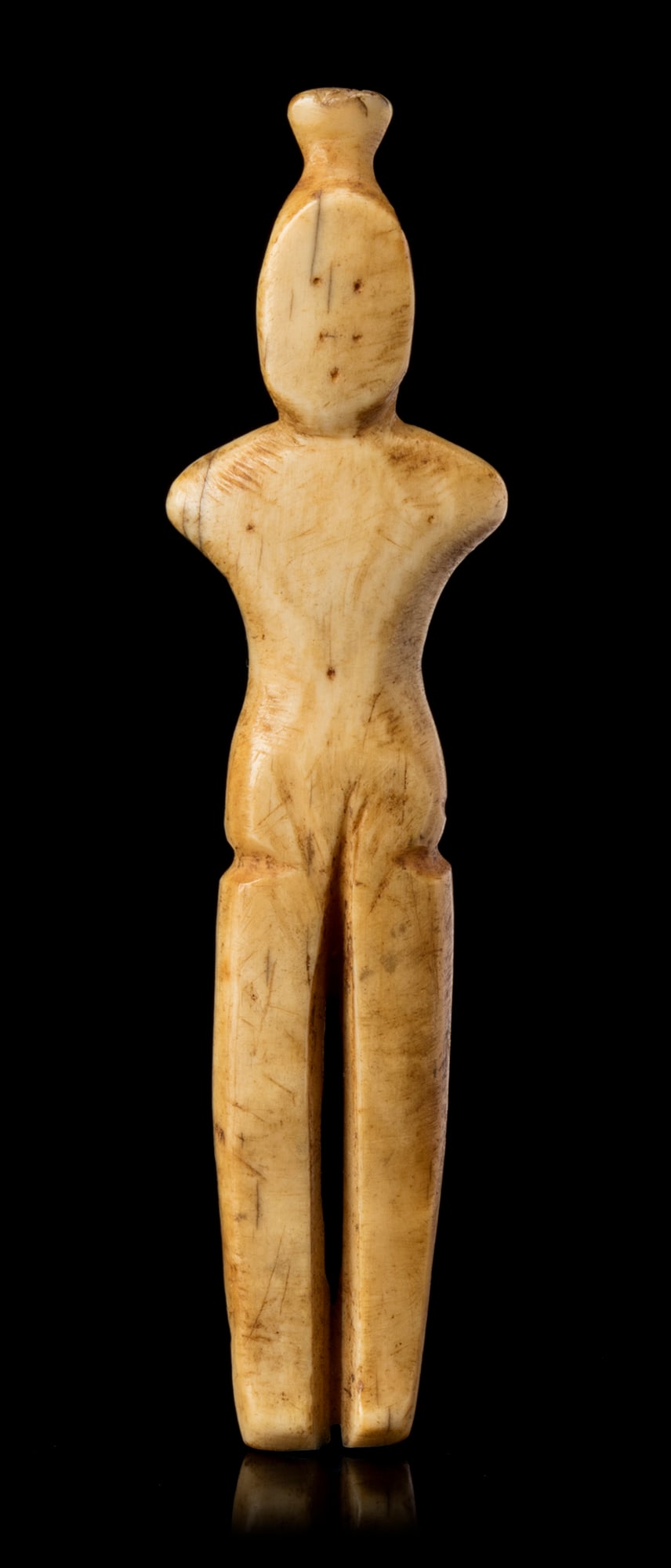 THULE CULTURE OR EARLY HISTORIC PERIOD INUIT ARTIST, POSSIBLY POND INLET AREA, Female Figurine, 19th: THULE CULTURE OR EARLY HISTORIC PERIOD INUIT ARTIST, POSSIBLY POND INLET AREA Female Figurine, 19th century or earlier walrus tusk, 3 x 0.75 x 0.25 in (7.6 x 1.9 x 0.6 cm) Provenance Collected by Will
