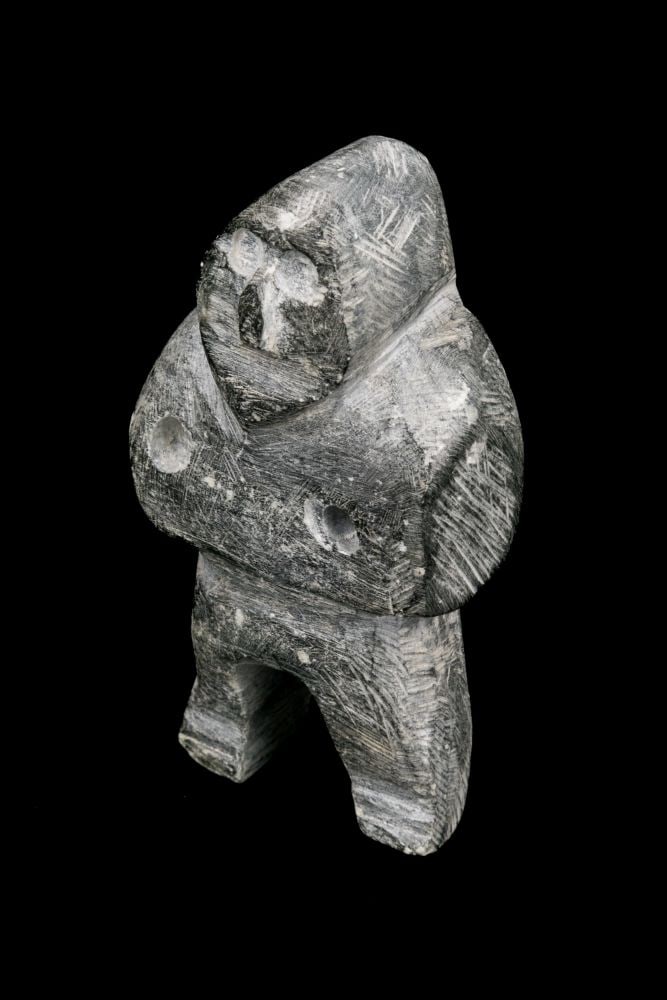 JOHN KAVIK, INUIT, Standing Man, early 1970s: JOHN KAVIK (1897-1993) KANGIQLINIQ (RANKIN INLET) Standing Man, early 1970s stone, 3.5 x 2 x 1.5 in (8.9 x 5.1 x 3.8 cm) signed, “ᑲᕕ”. Provenance Private Collection, Toronto. B
