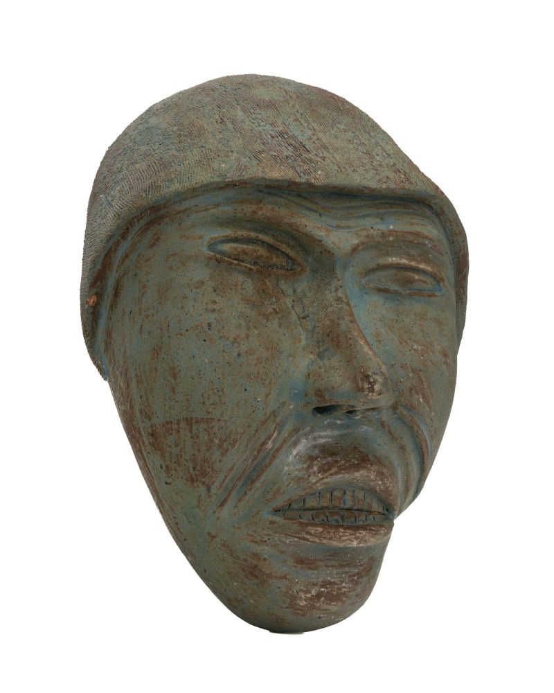 YVOO SAMGUSAK MANGELIK, INUIT, Face of a Man, c. 1973-75: YVOO SAMGUSAK MANGELIK (1942-2013) KANGIQLINIQ (RANKIN INLET) Face of a Man, c. 1973-75 glazed ceramic, 11.5 x 8.5 x 4.5 in (29.2 x 21.6 x 11.4 cm) signed and inscribed with artist's disc number, "